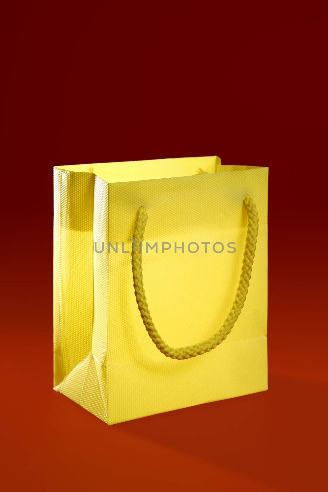 Shopping bag over red background by lunamarina