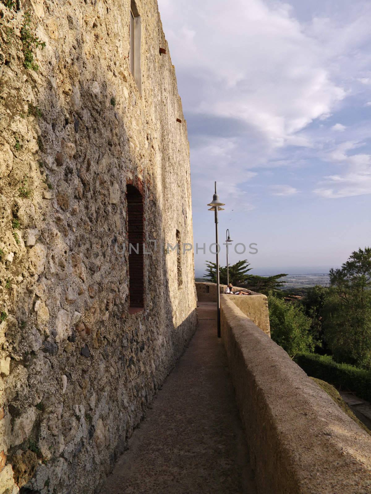 italy, tuscany, Capalbio town, tourists relax  and enjoy the sunset on external walls