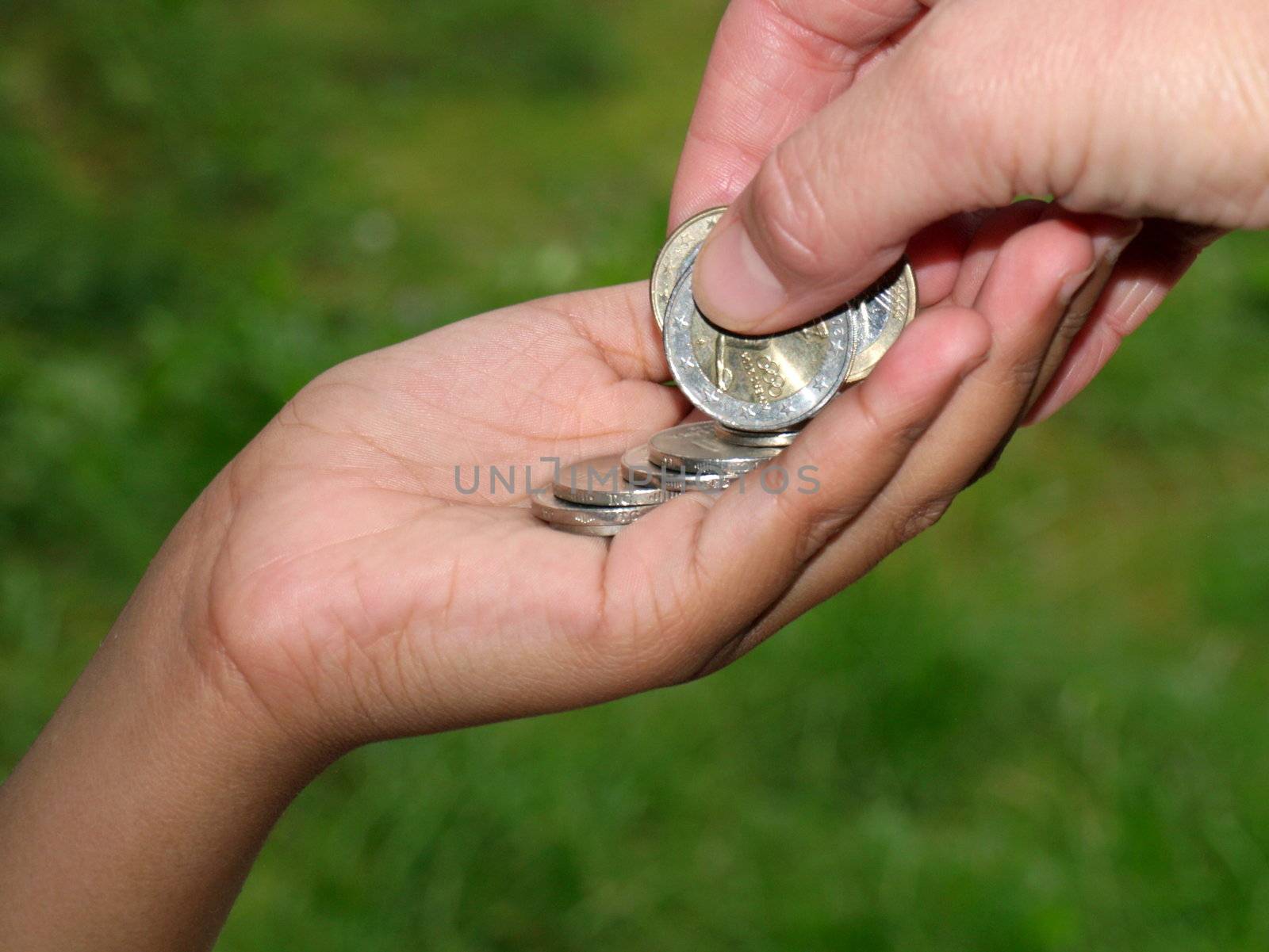 giving coins to kids hand