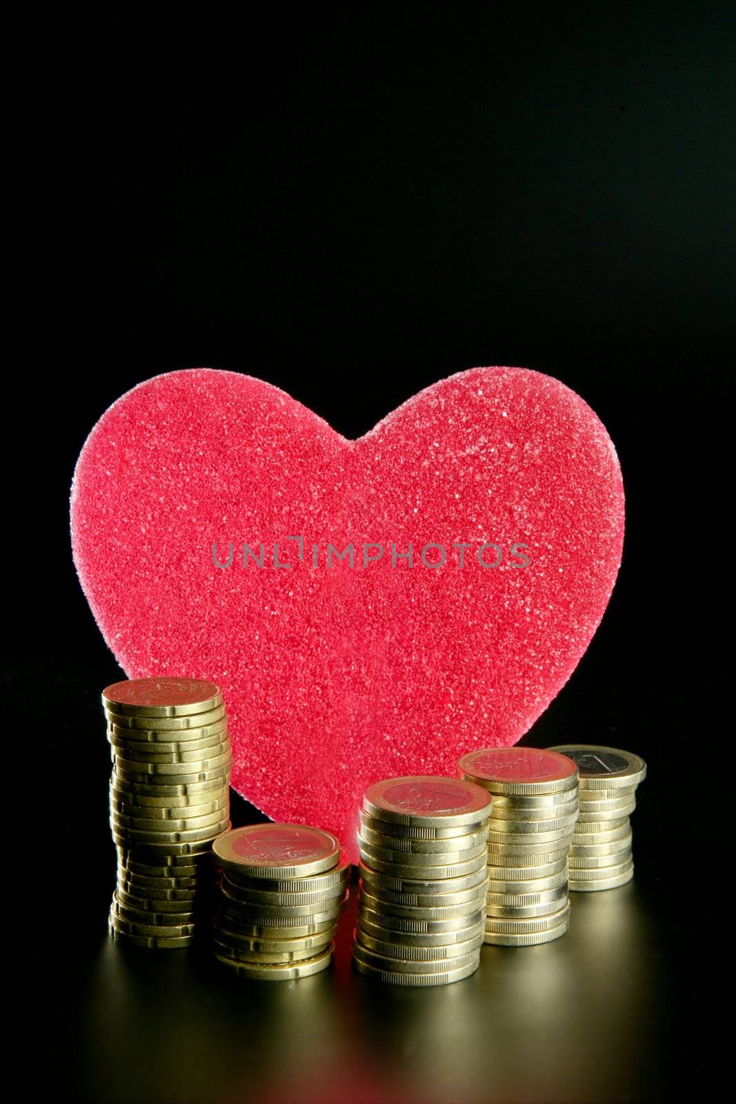 Love and money metaphor. Valentines candy heart and euro coins