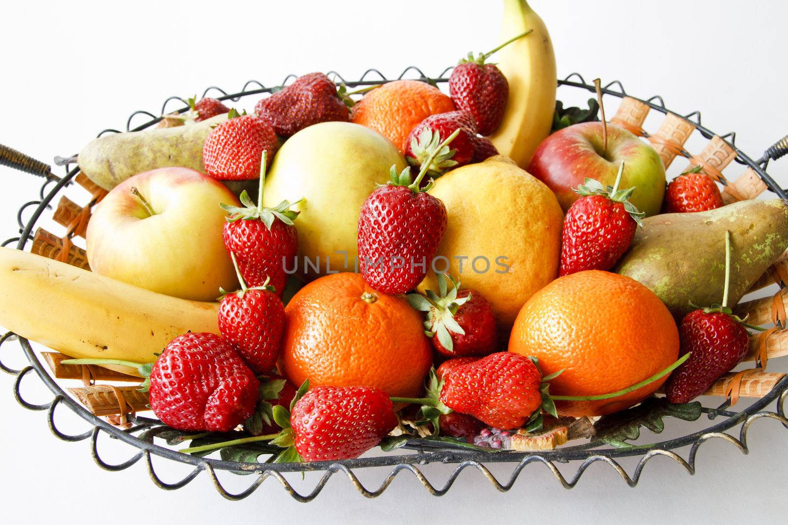 Fruits basket with strawberries, pears, apples, lemon, oranges, bananas