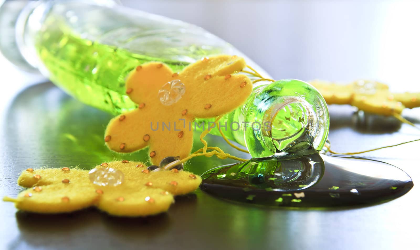 Bottle with bath gel with yellow flowers on table