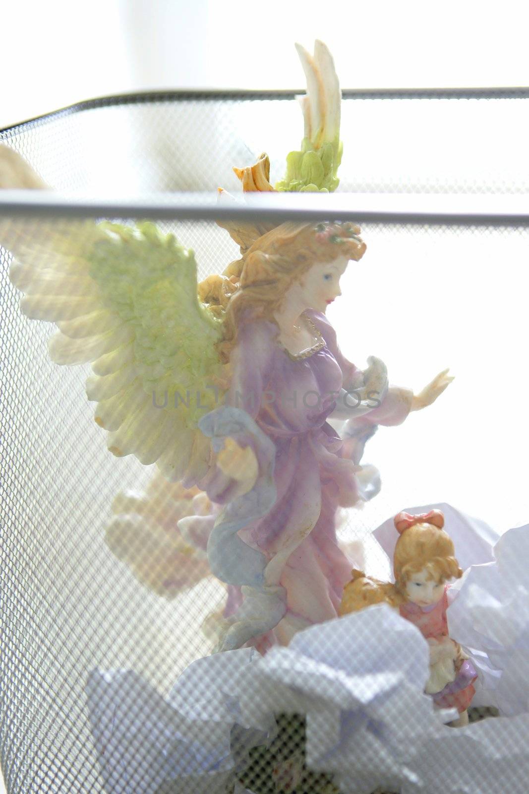 angel saint figure in the office trash by lunamarina