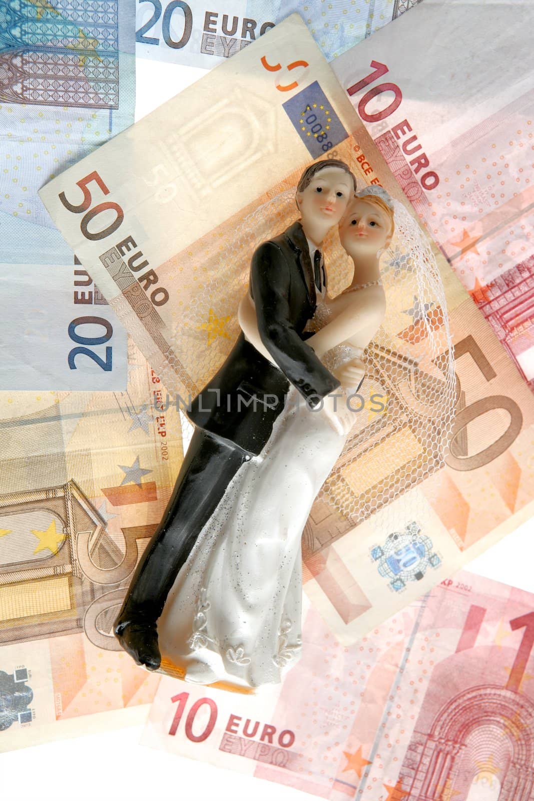 wedding couple figurine over euro notes by lunamarina