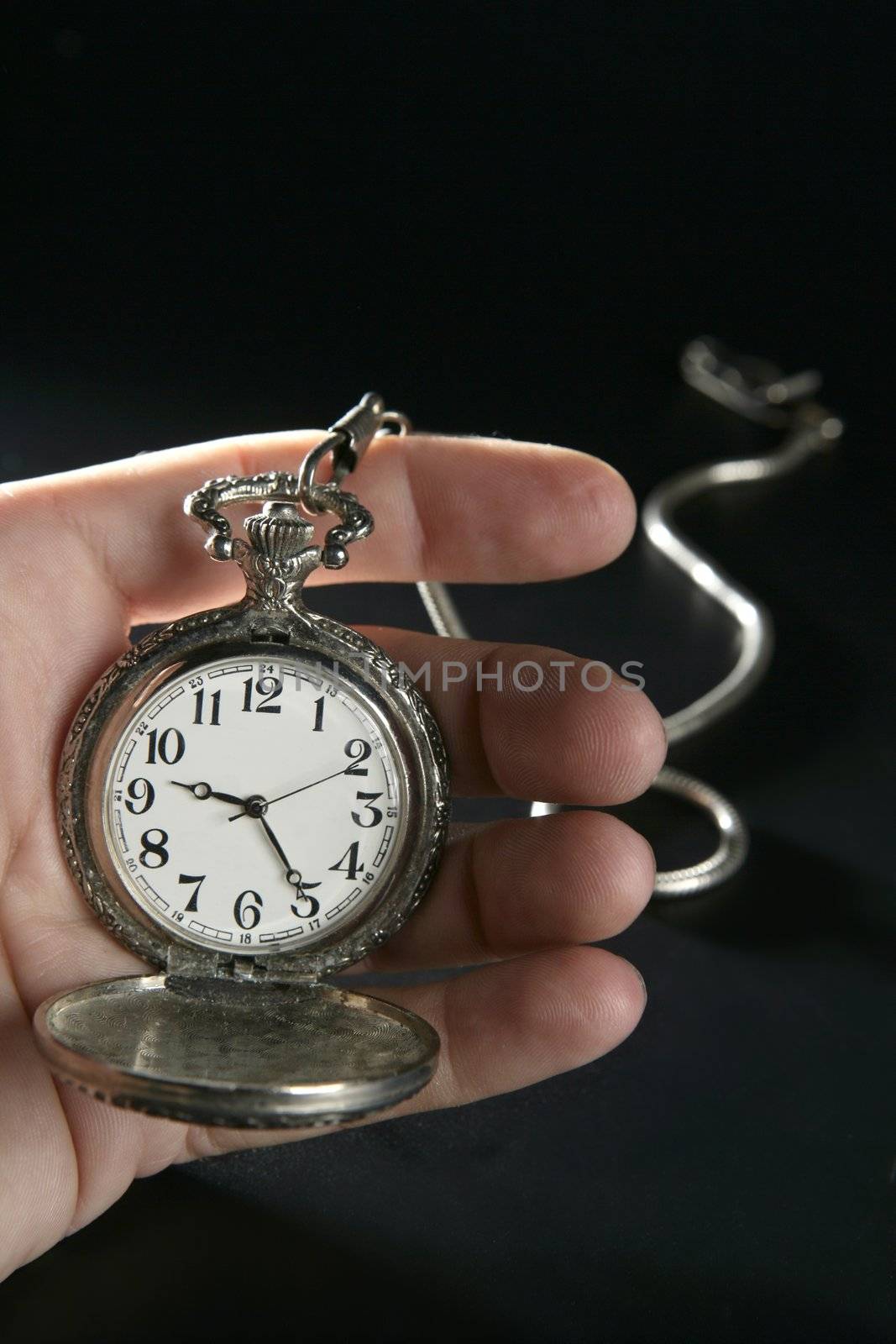 old silver pocket watch clock on human hand by lunamarina