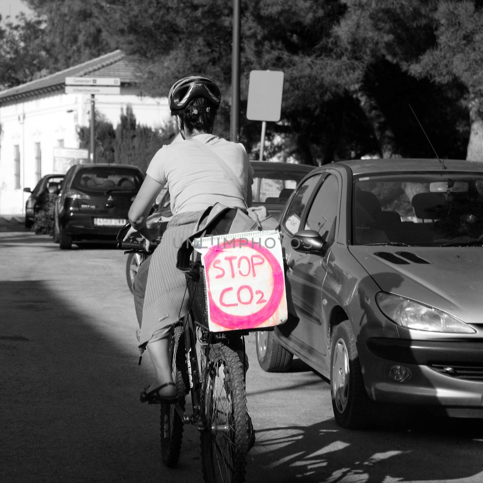 woman in bicyle with a message: stop co2 by lunamarina