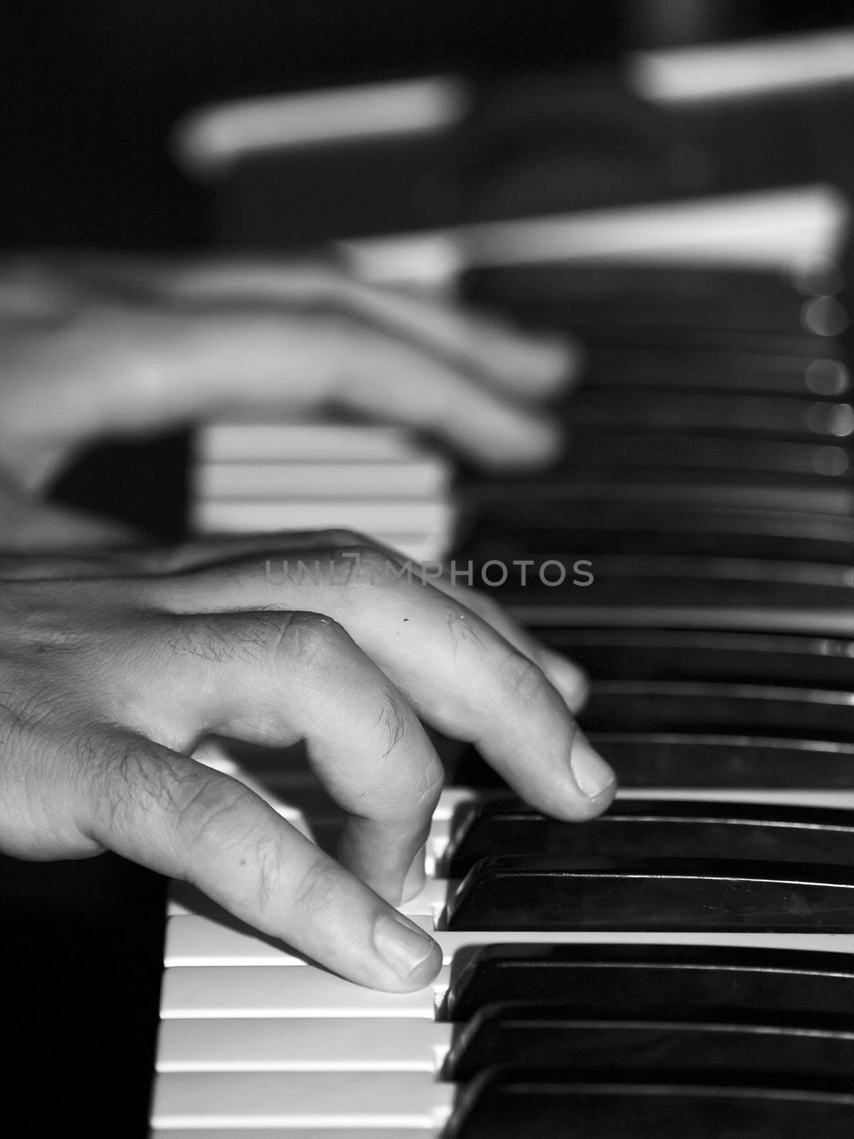 Detail of hands playing a piano or keyboard instrument