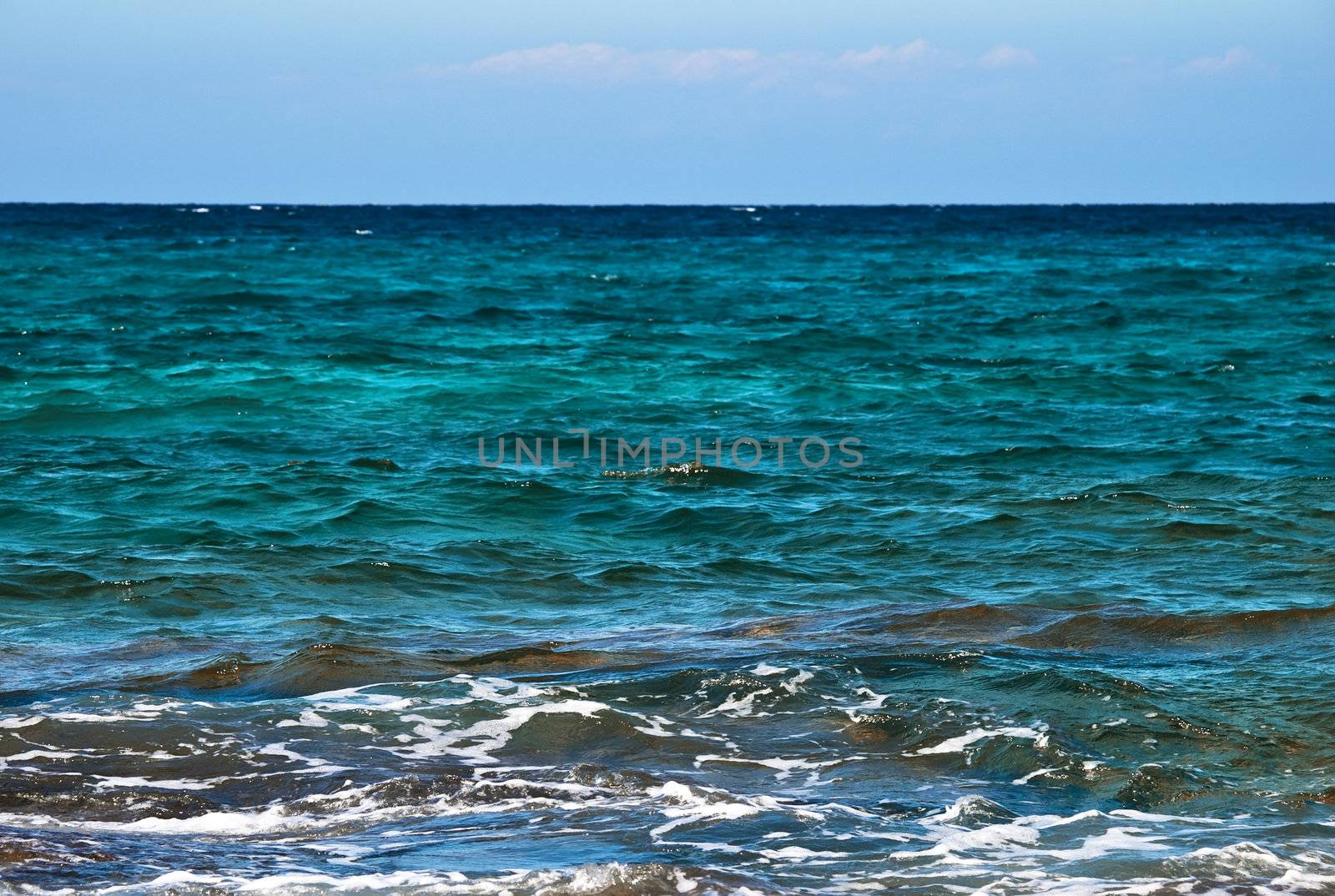 Crystal clear blue and emerald Mediterranean waters at the coast in Malta