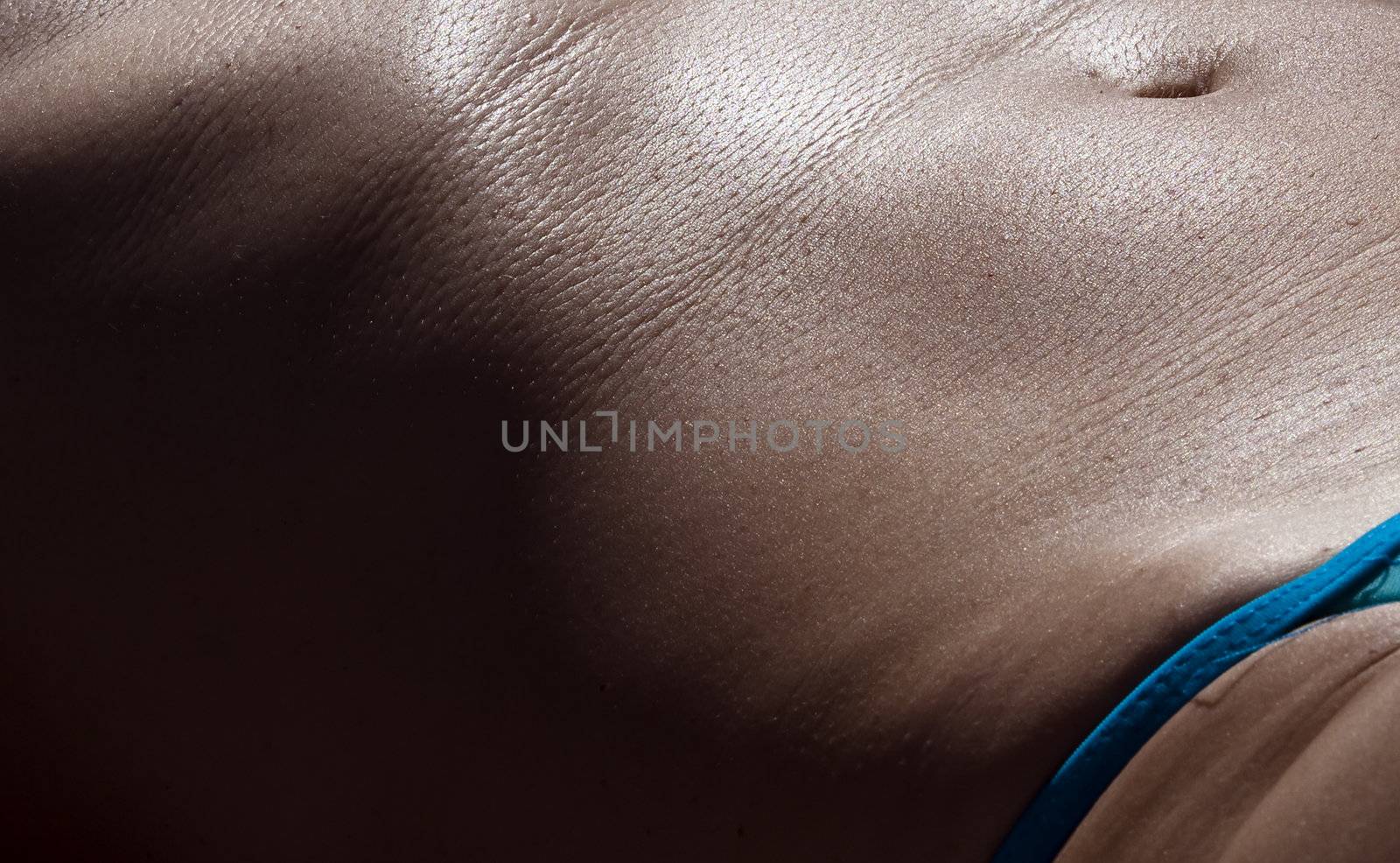 Abstract detail image of tanned woman in bikini sunbathing in the Mediterranean