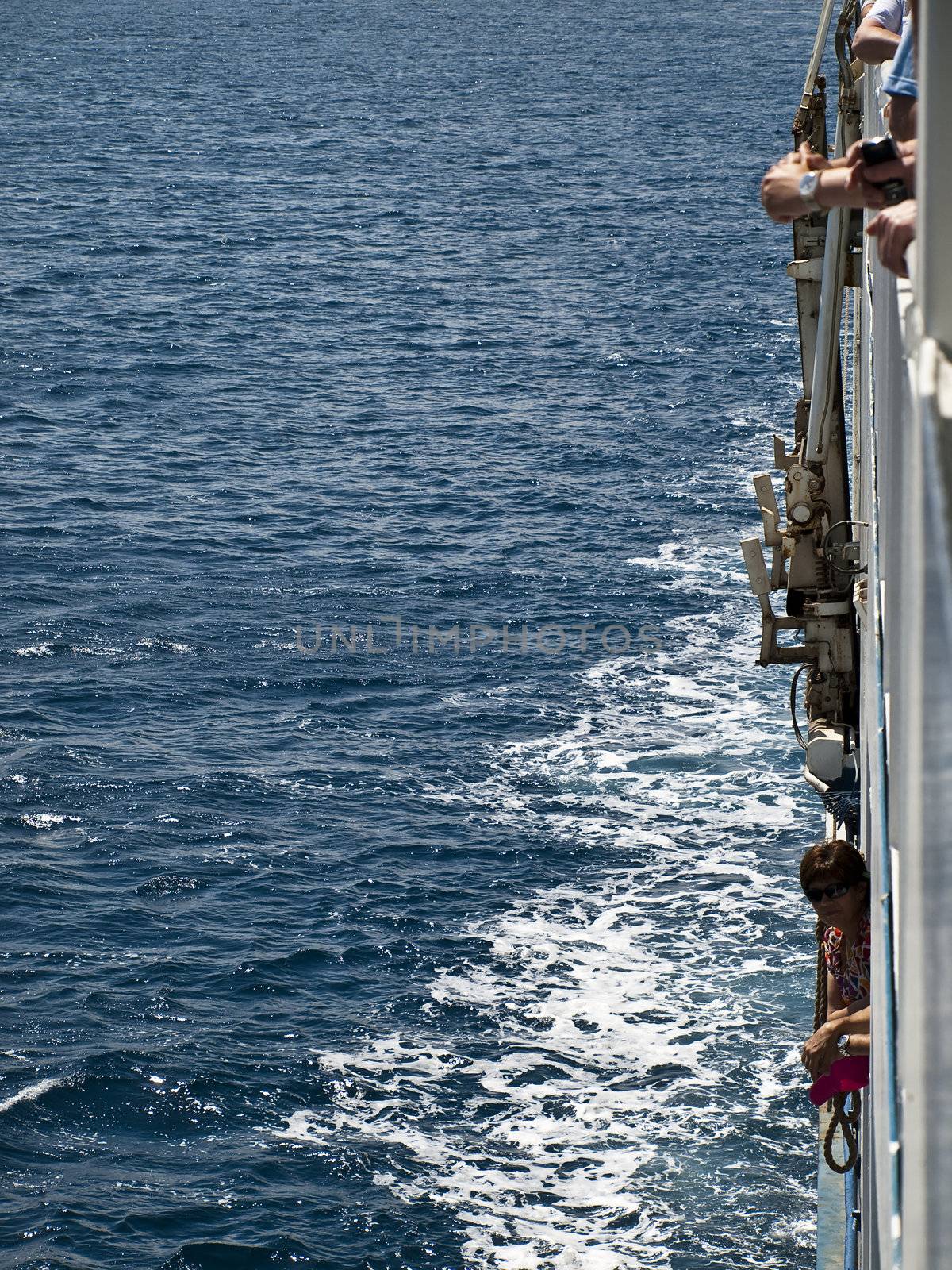 Passengers having a look overboard on the ferry boat service between Malta and sister island Gozo