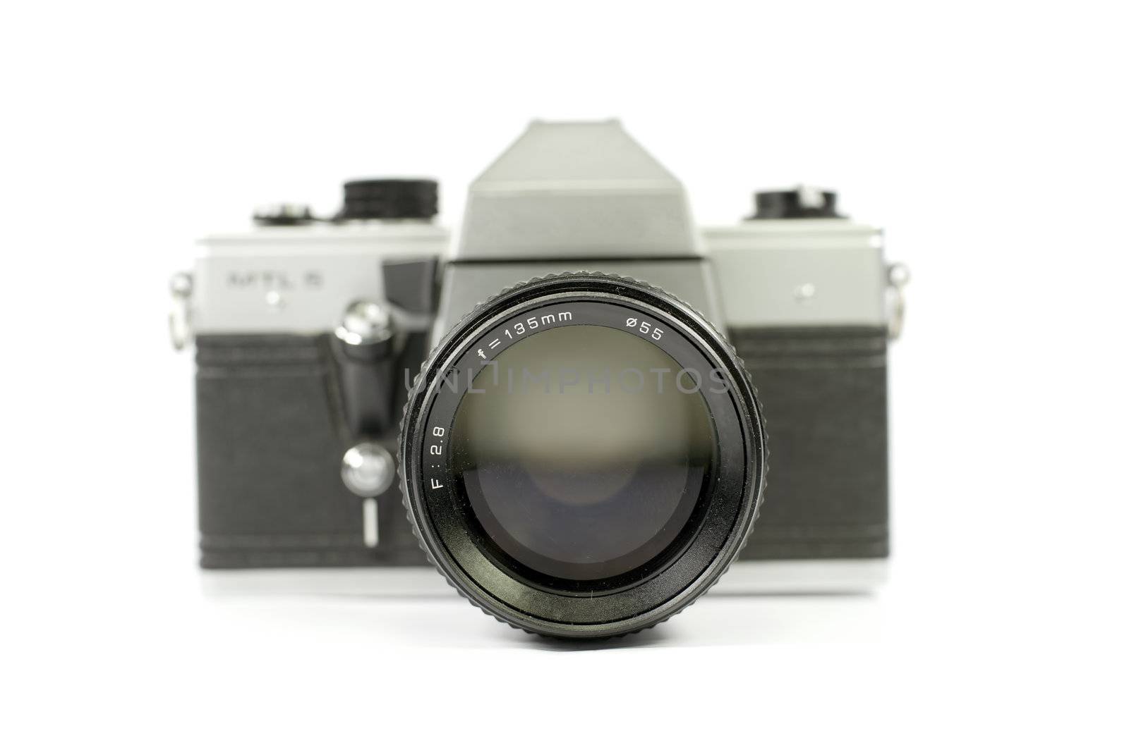 Front view of an old film camera with its telephoto lens