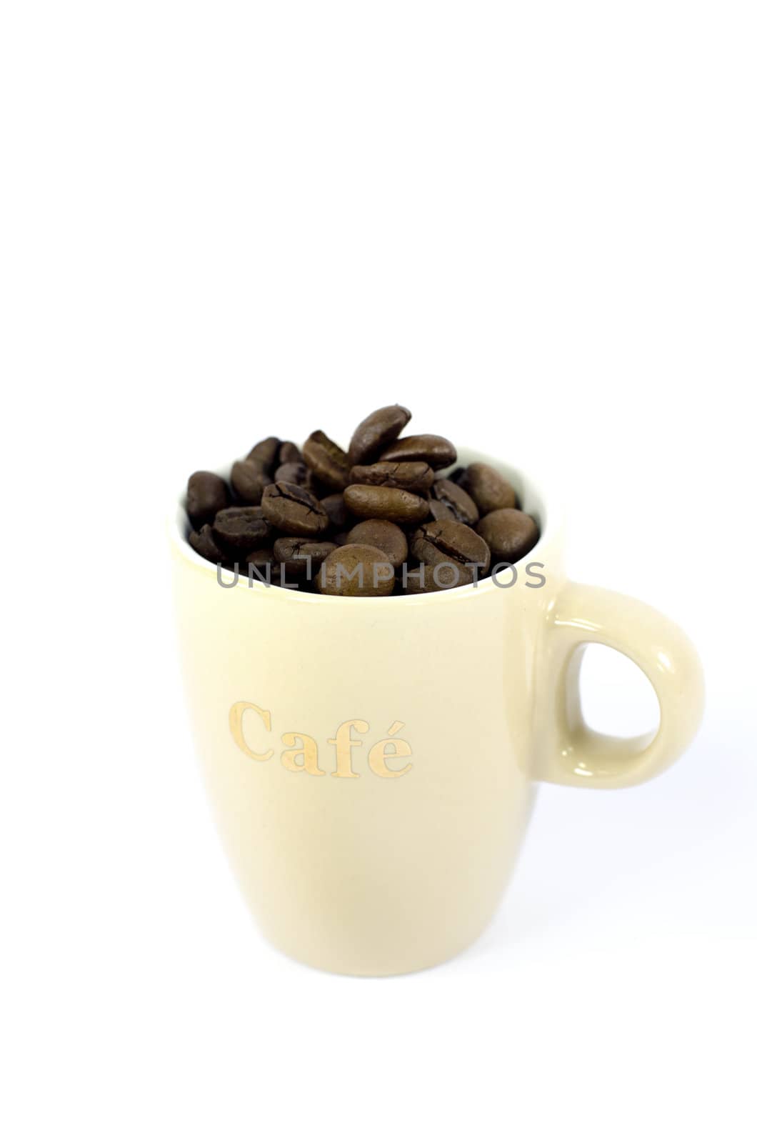 a little cup with coffee beans on white background