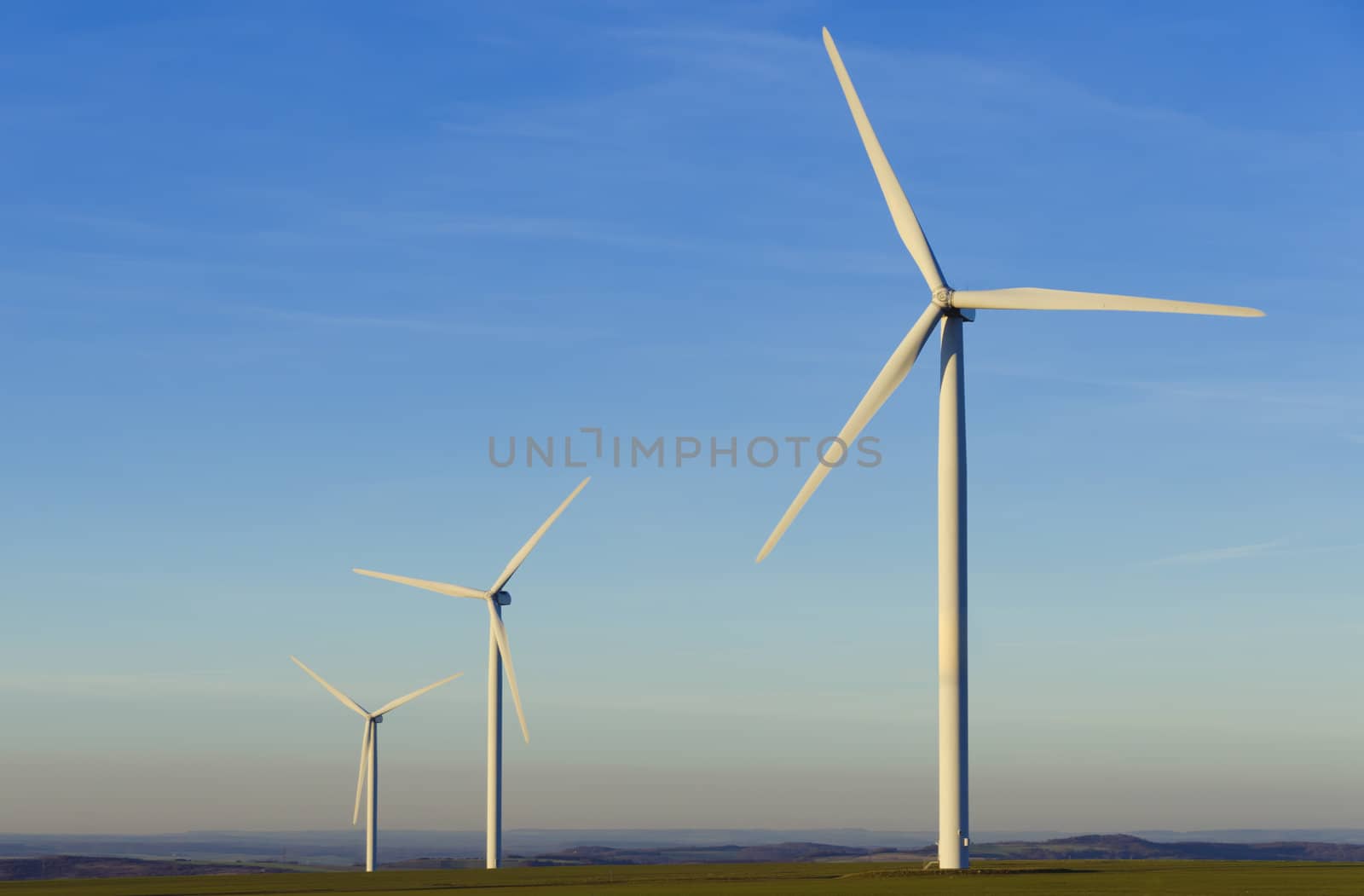 three windmills in the countryside