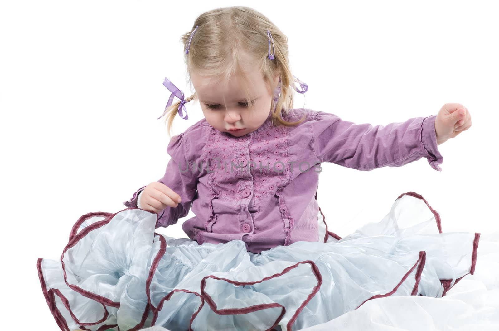 A little girl sitting on the floor in studio