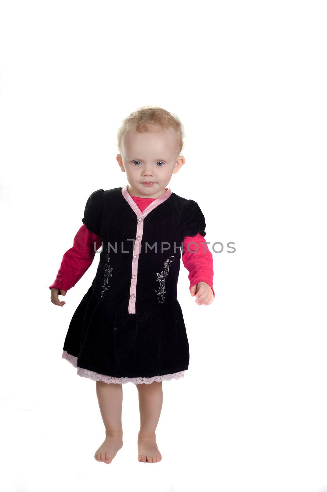 Shot of standing toddler in studio in black dress