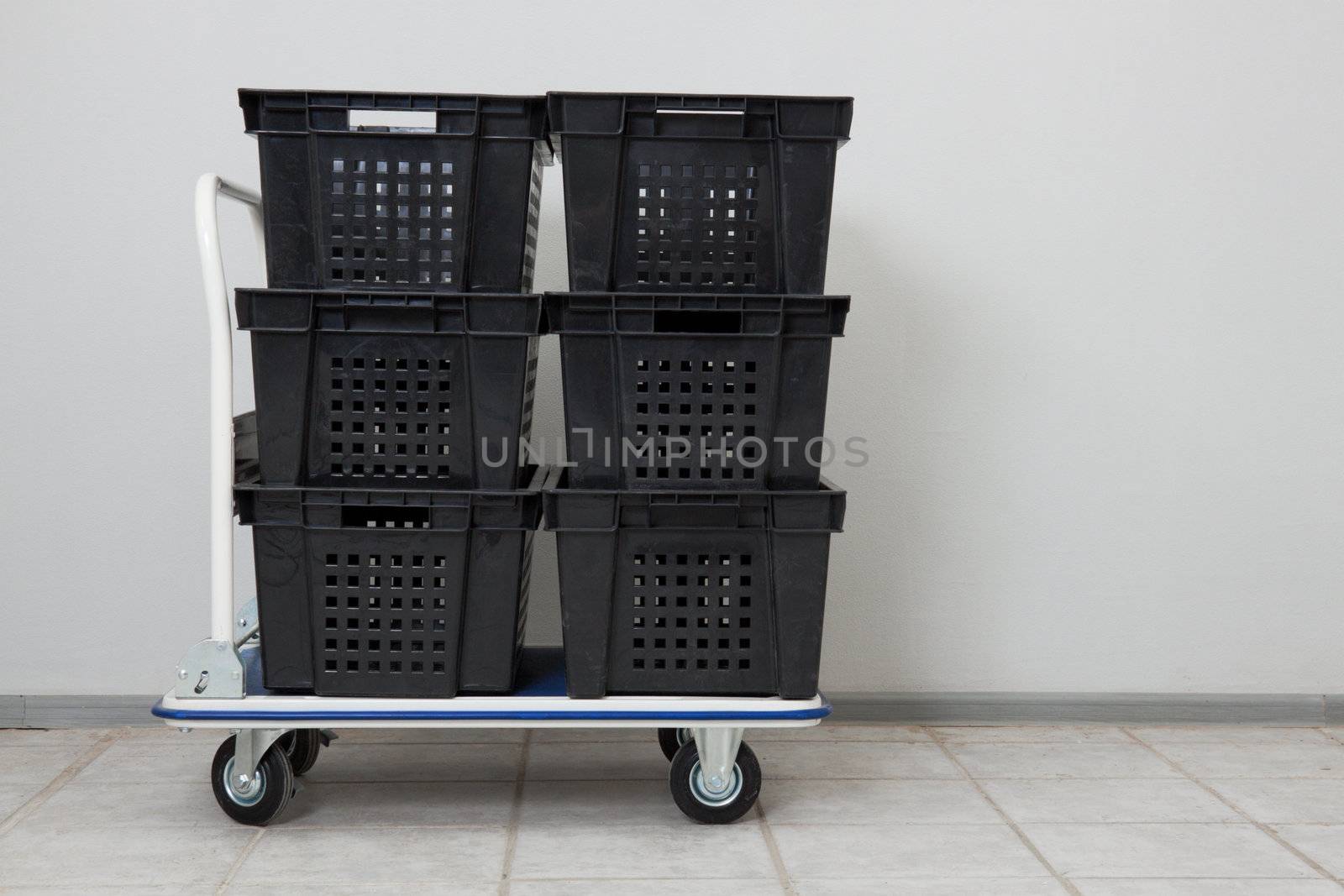 Industial warehouse cart with the stack of empty conainers