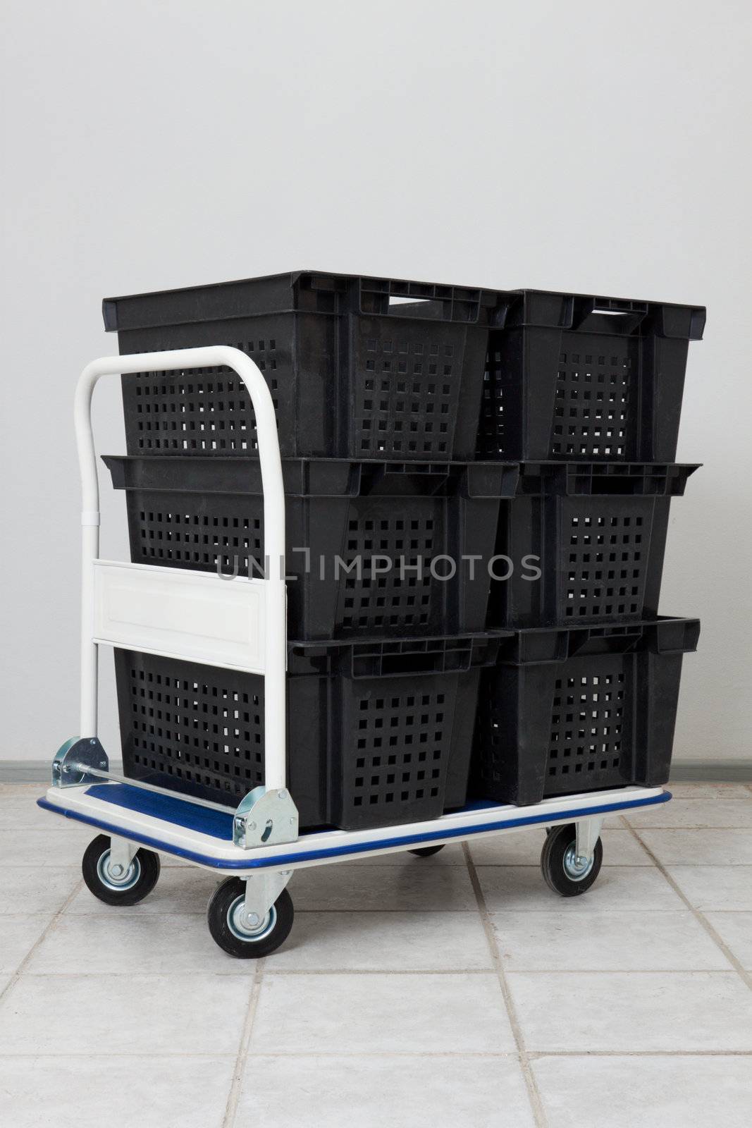 Industial warehouse cart with the stack of empty conainers