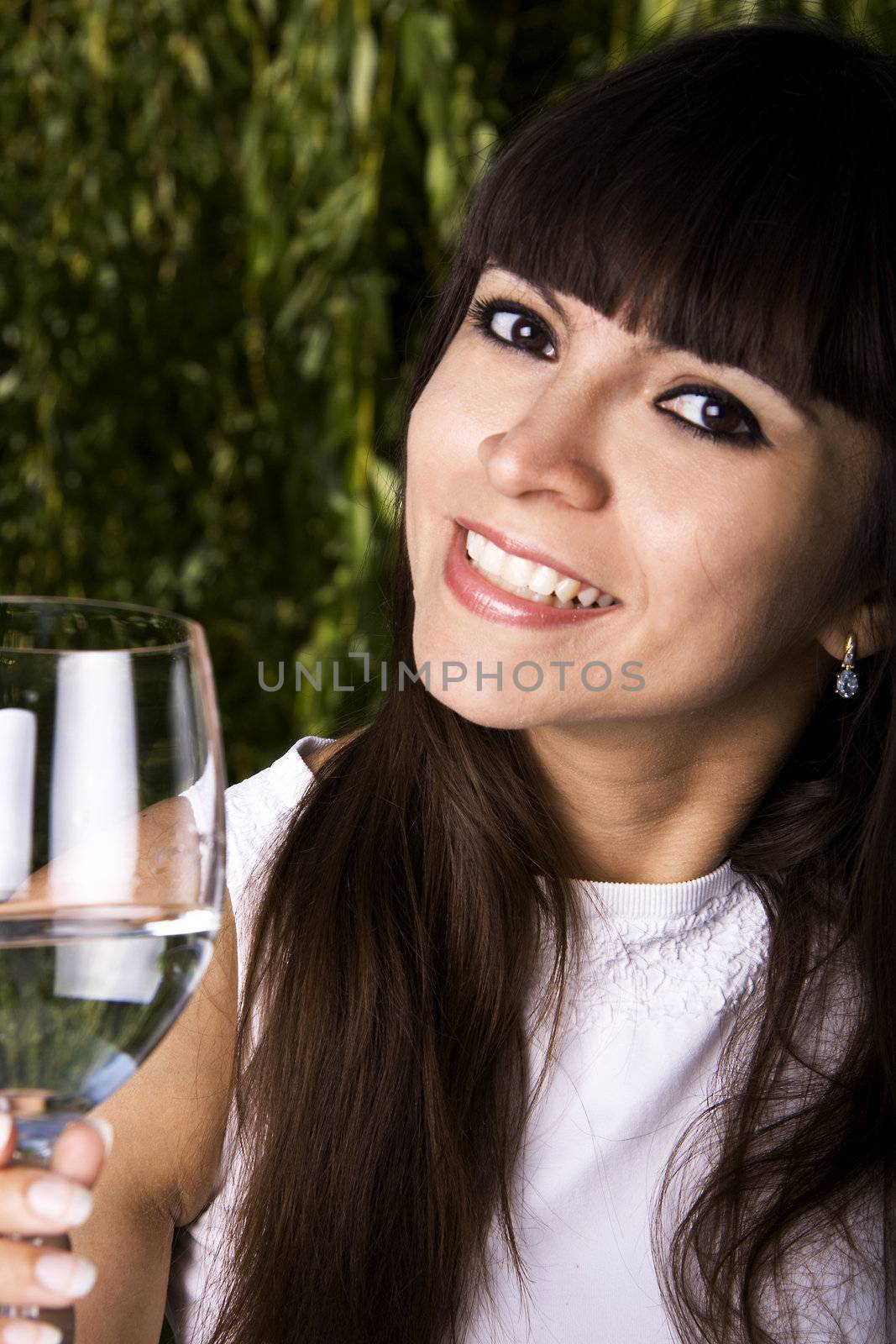 Beautiful stylish latina woman is drinking champagne