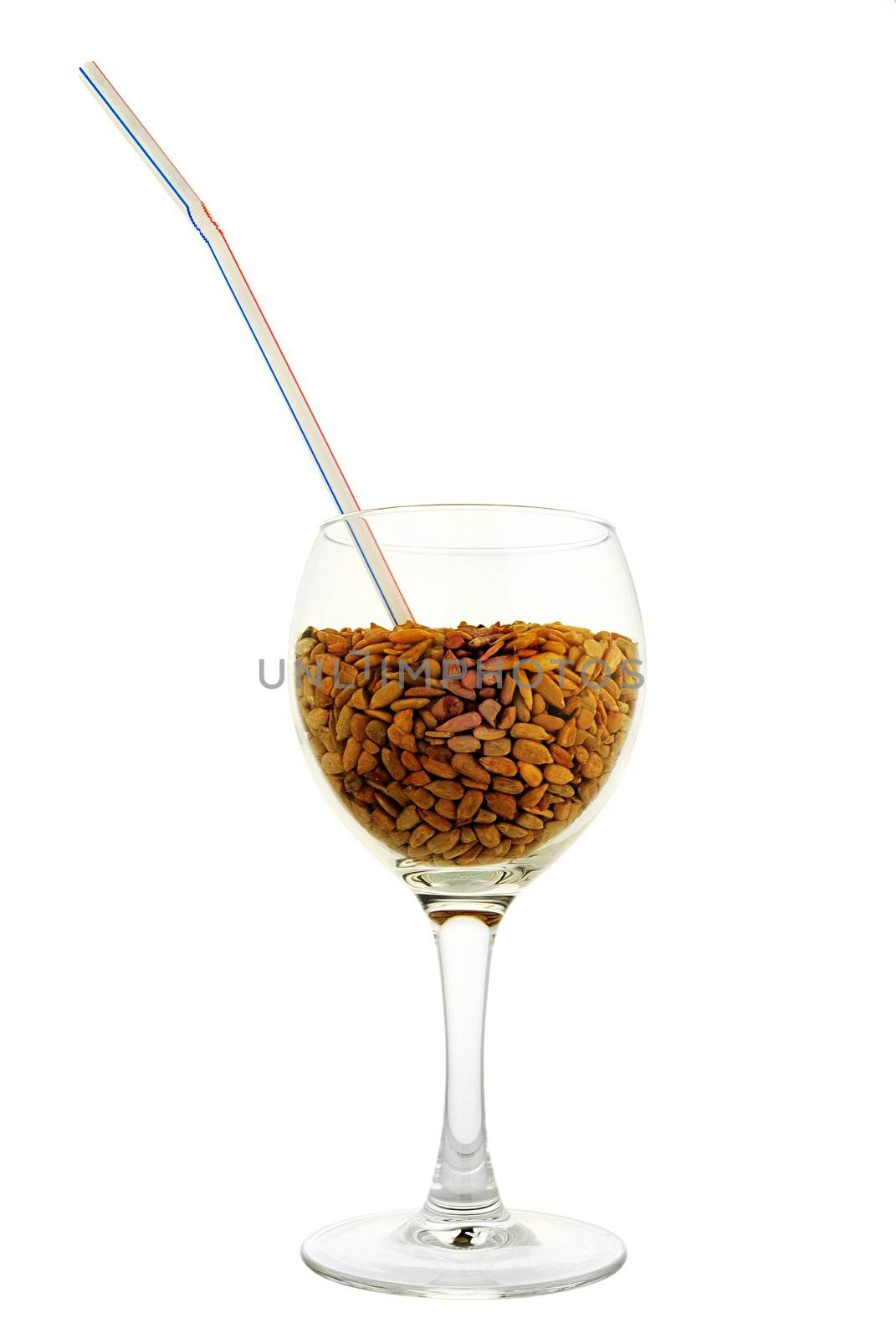 Cocktail: glass with cleared seeds of sunflower and straw