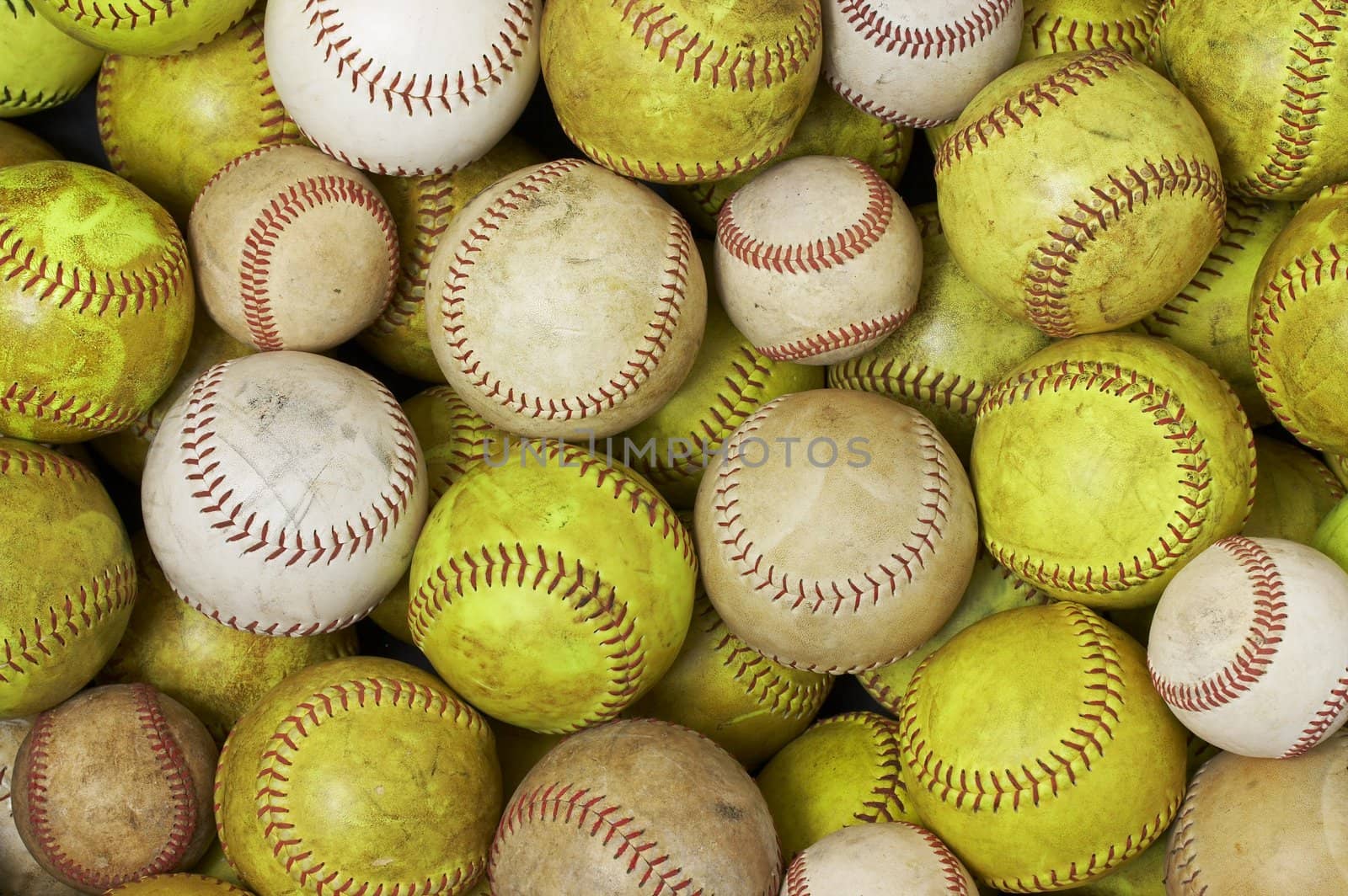 a picture of old softballs and baseballs