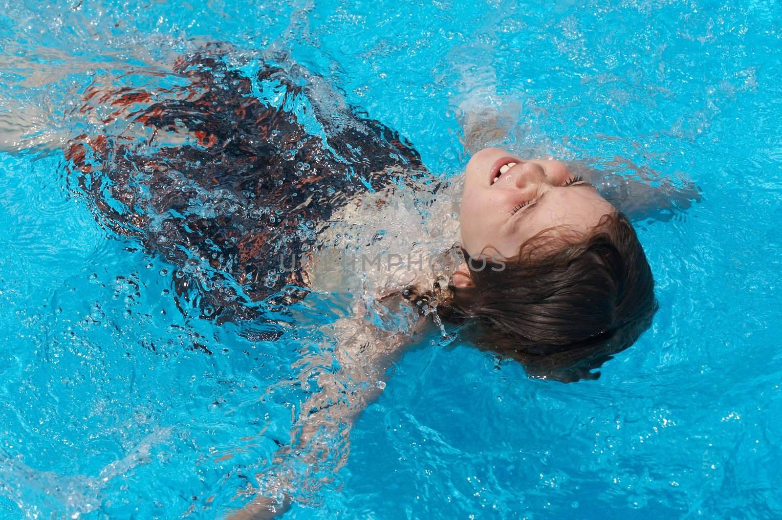 a boy playing in swimming pool