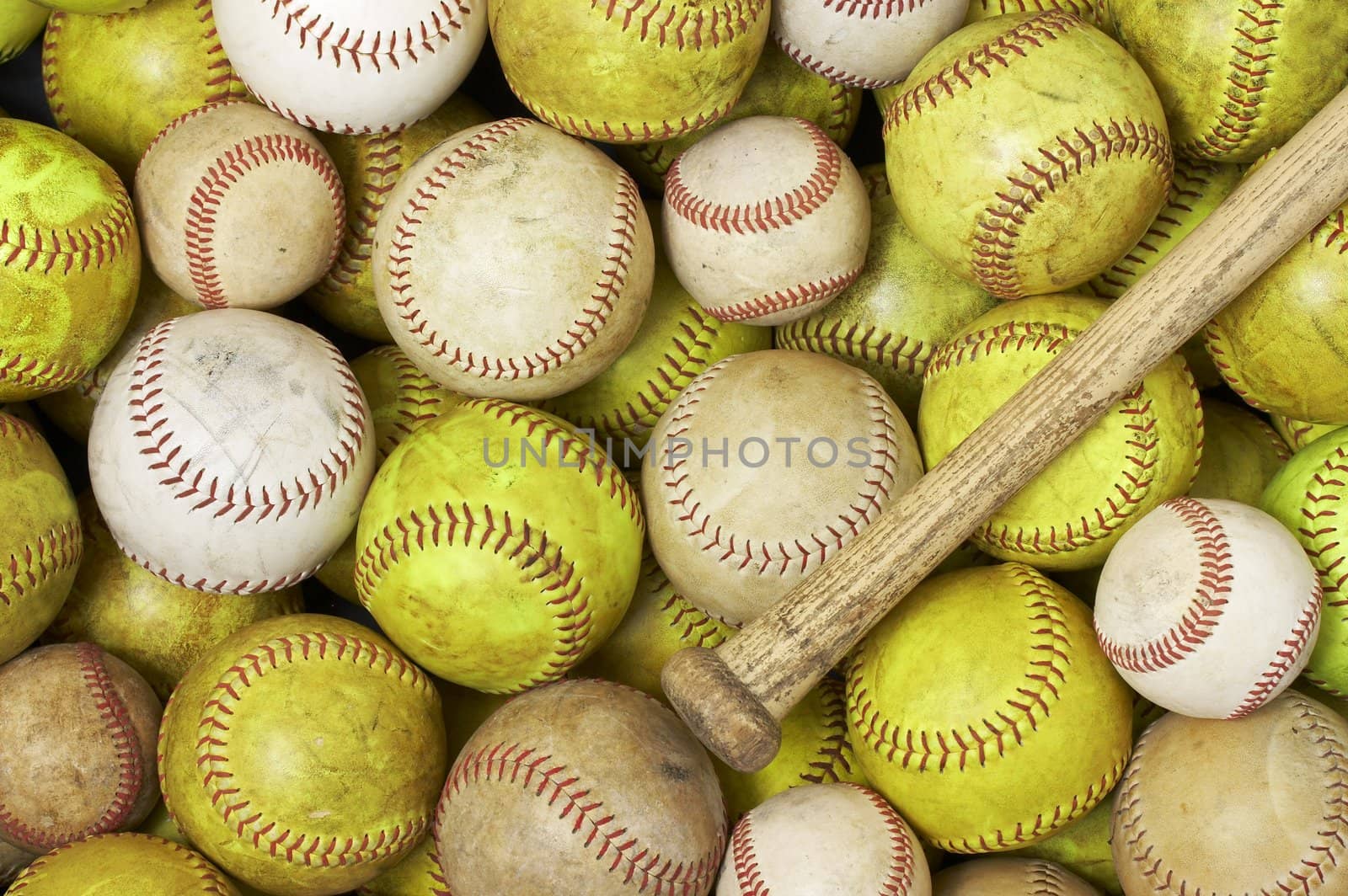 a picture of baseballs softballs and a bat