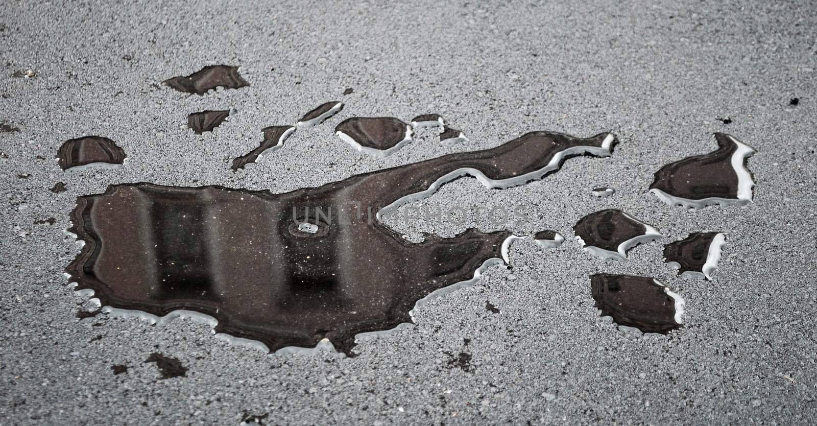 drops of rain water on a fresh asphalt by Sergieiev