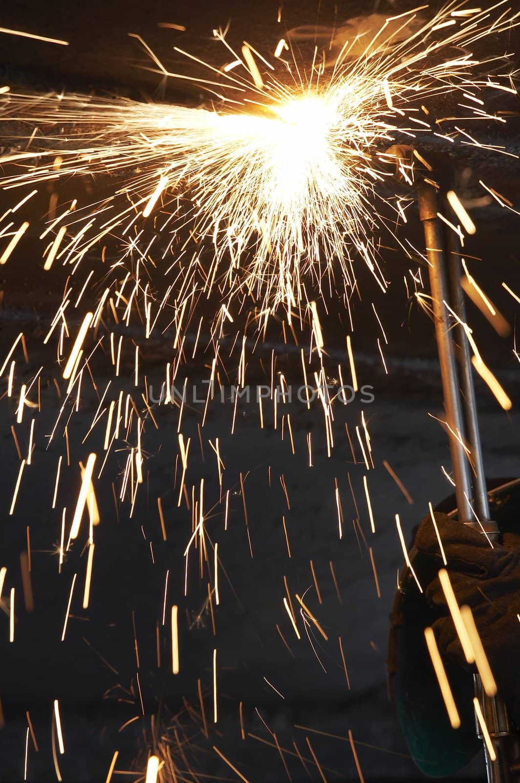 a steel worker burning metal with a torch