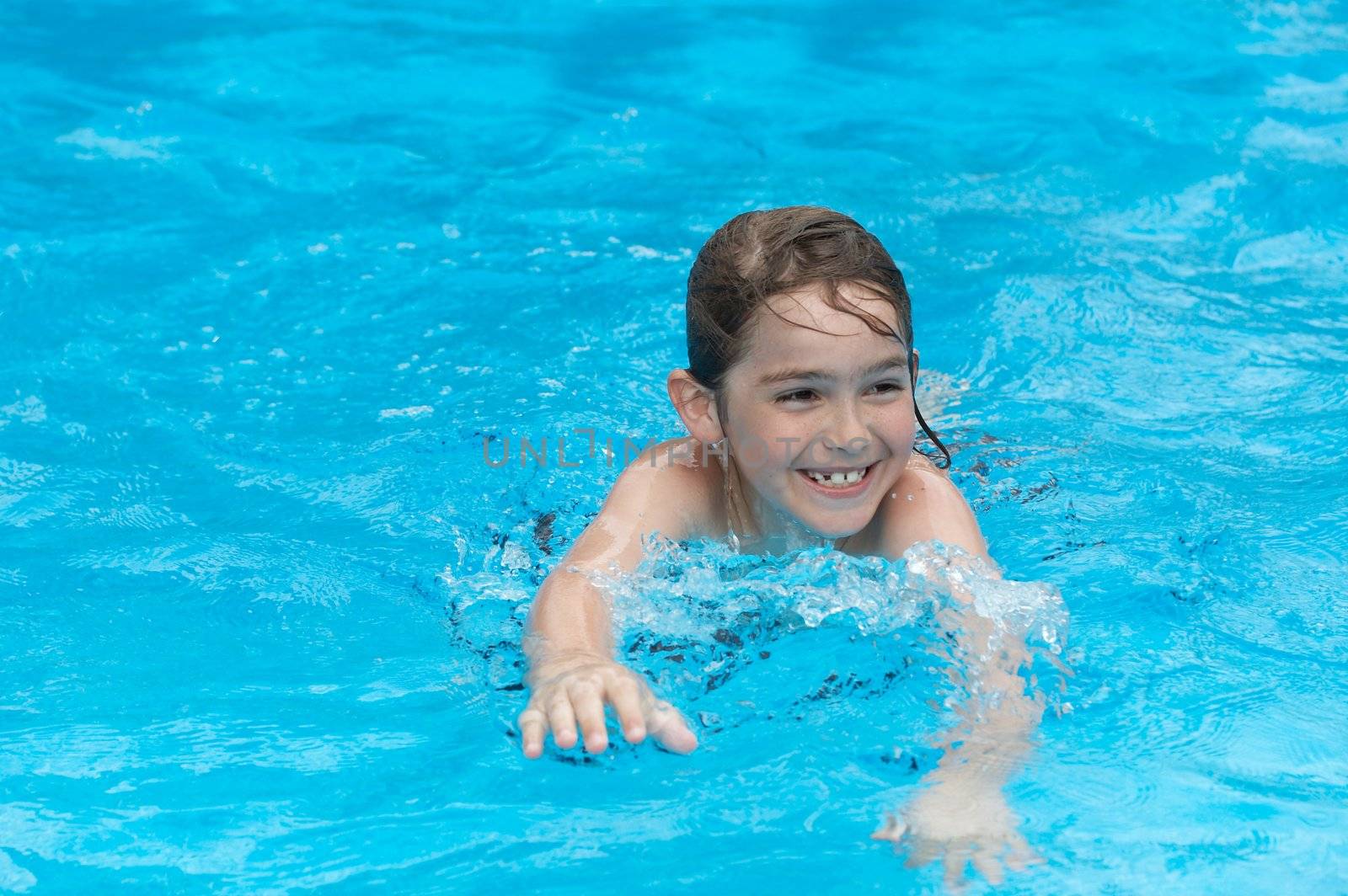 a boy smiling in swimming pool