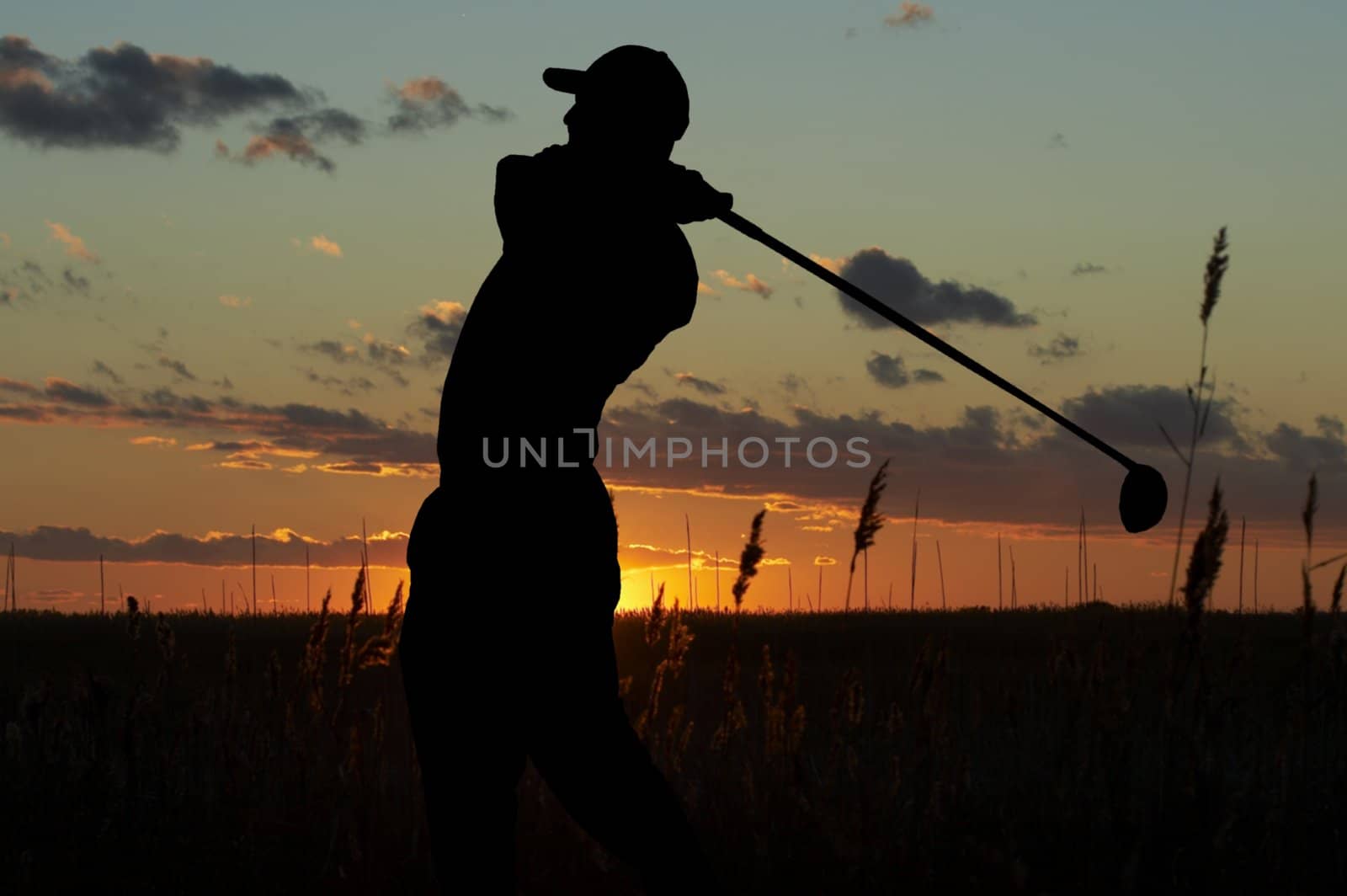 a silhouette of a golfer on a mourning sunset