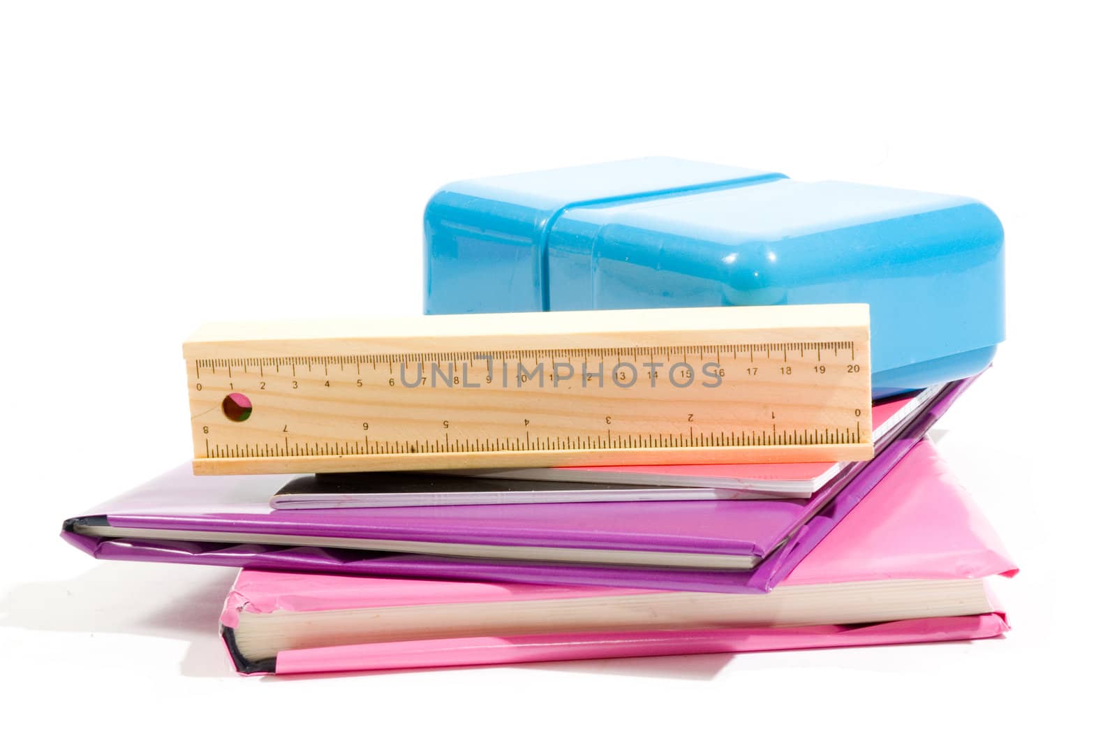 stack of books with school supply isolated on white