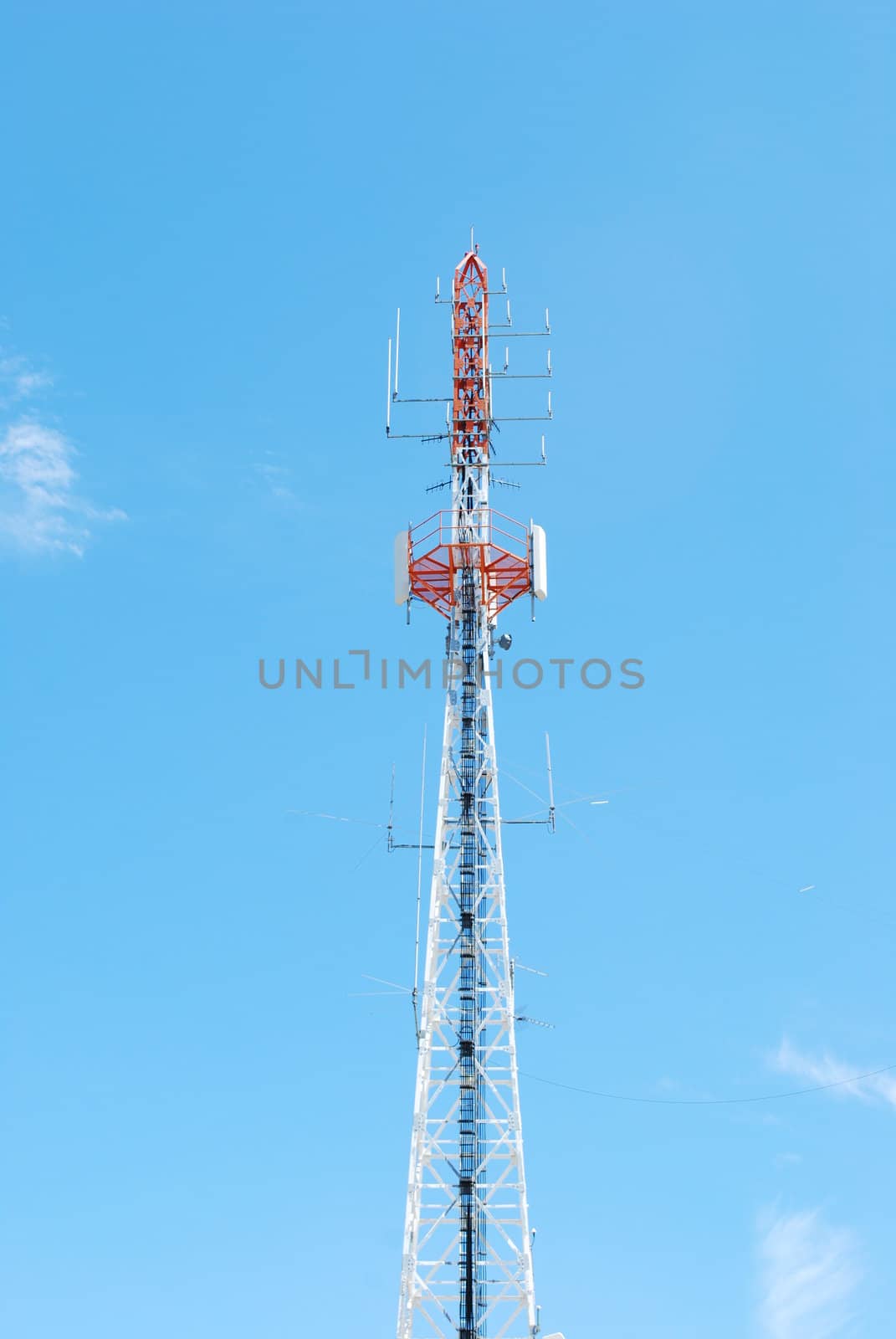 photo of a communication tower against blue sky background