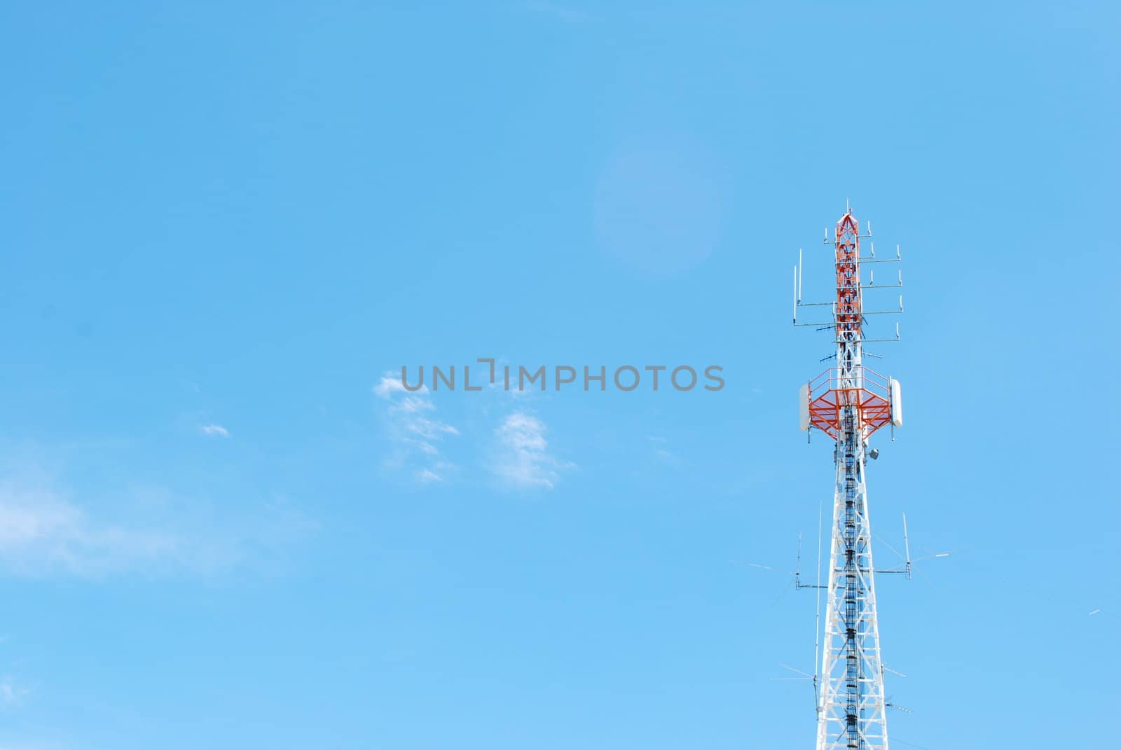 photo of a communication tower against blue sky background