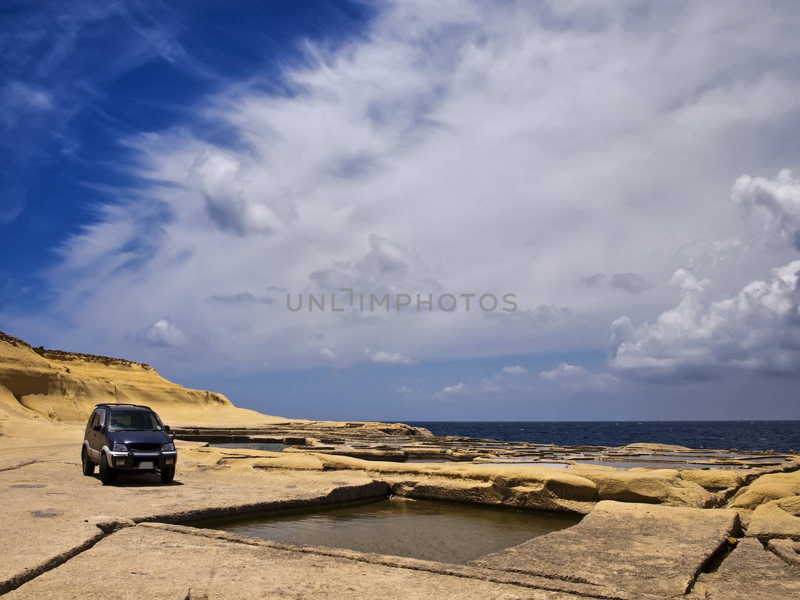 Offroad SUV on sandstone plains in Qbajjar in Gozo