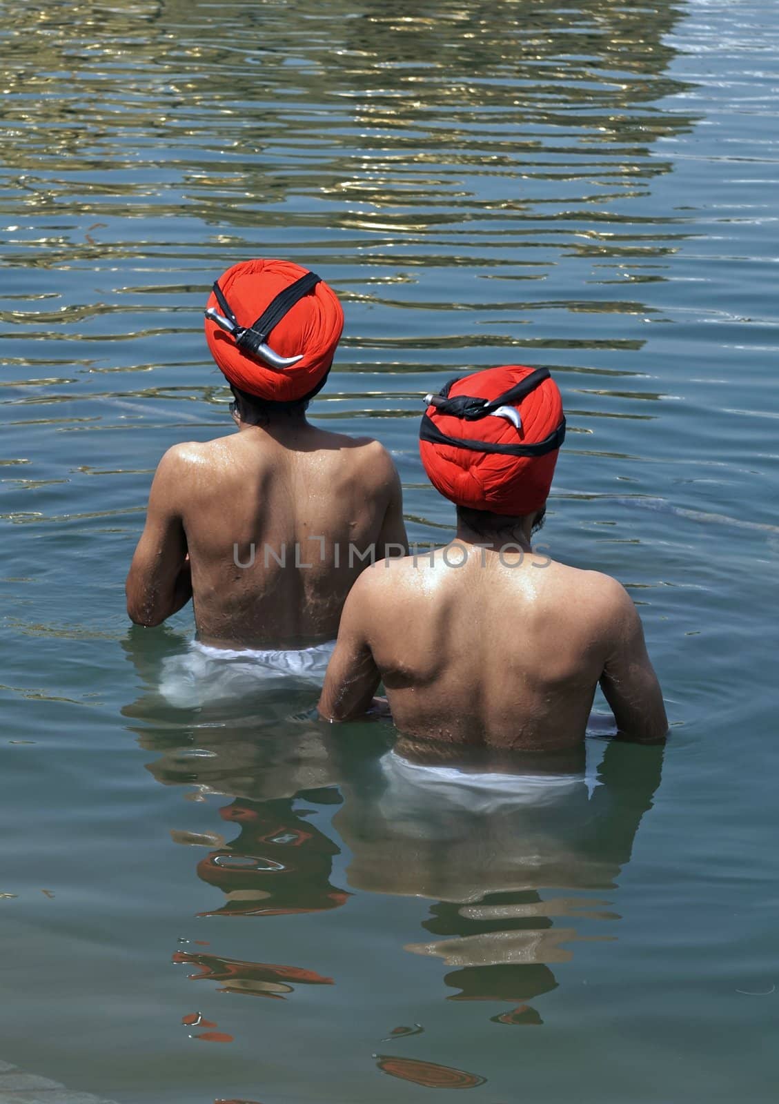 Sikh men bathing in the holy pool at the Golden Temple, Amritsar