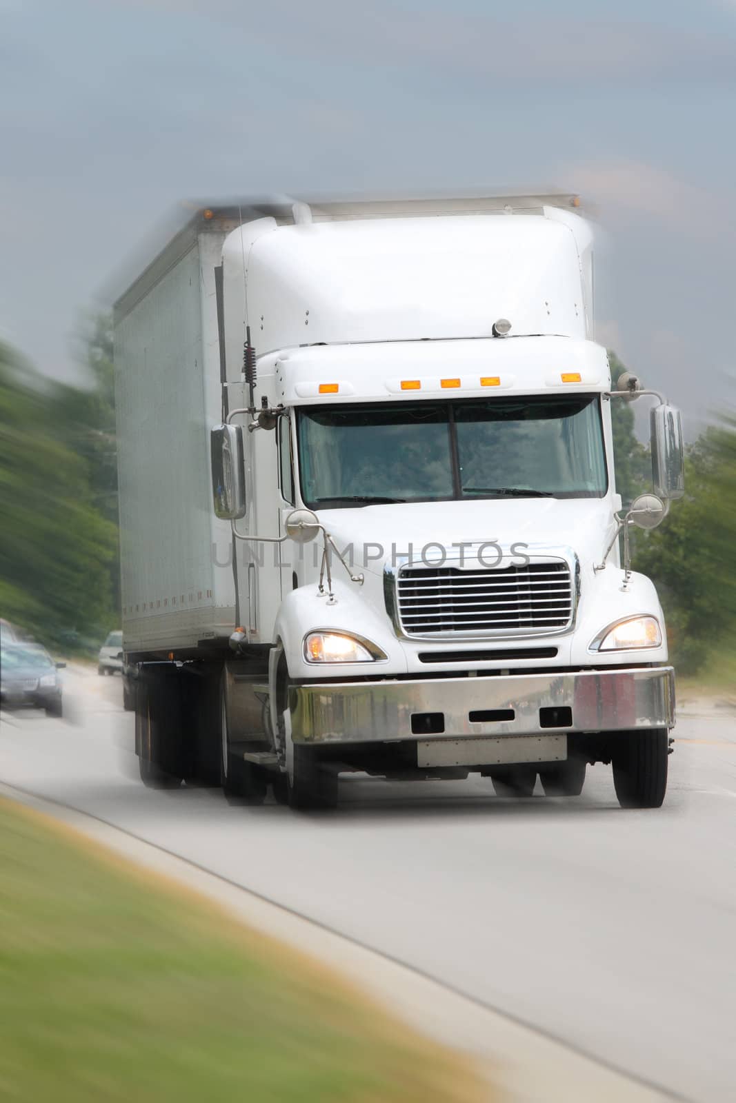 white freight truck driving on road