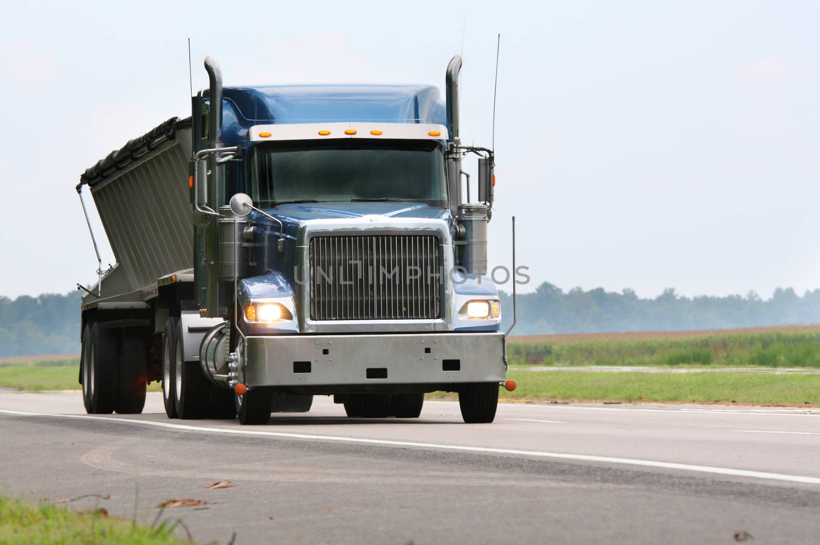 blue cargo truck driving down road