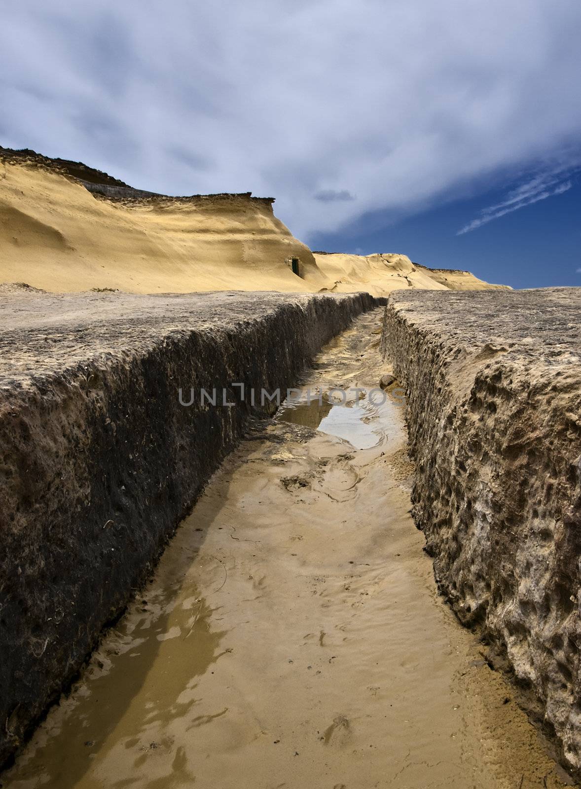 Image shot through rut carved in stone giving impression of a valley