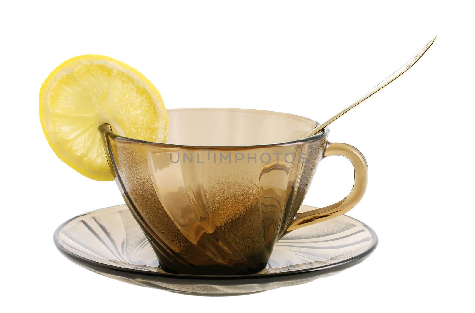 Glass transparent cup with spoon  and lemon. Heat-tolerant utensils 