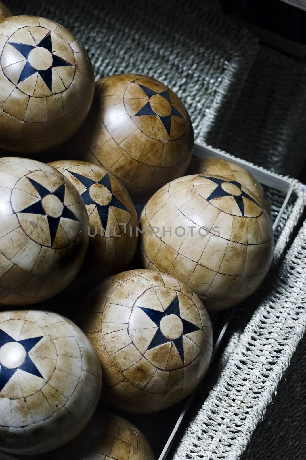 Decorative woos balls with five pointed stars in a basket
