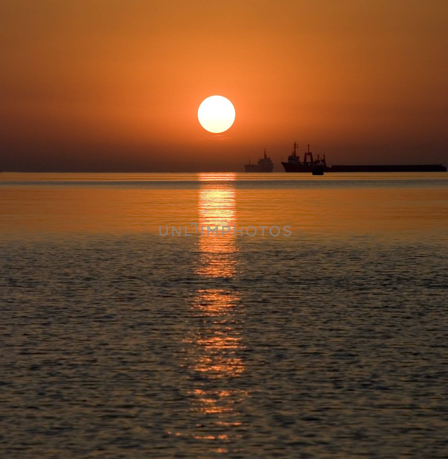 The ships on a background sunset. Coast of pacific ocean