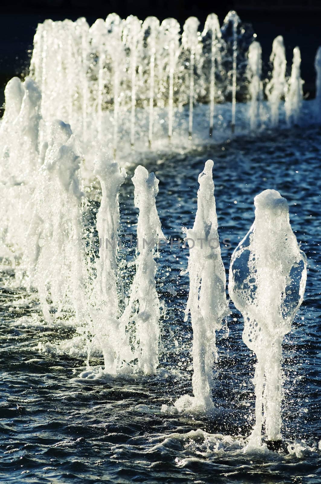 Row of water jets in a urban fountain