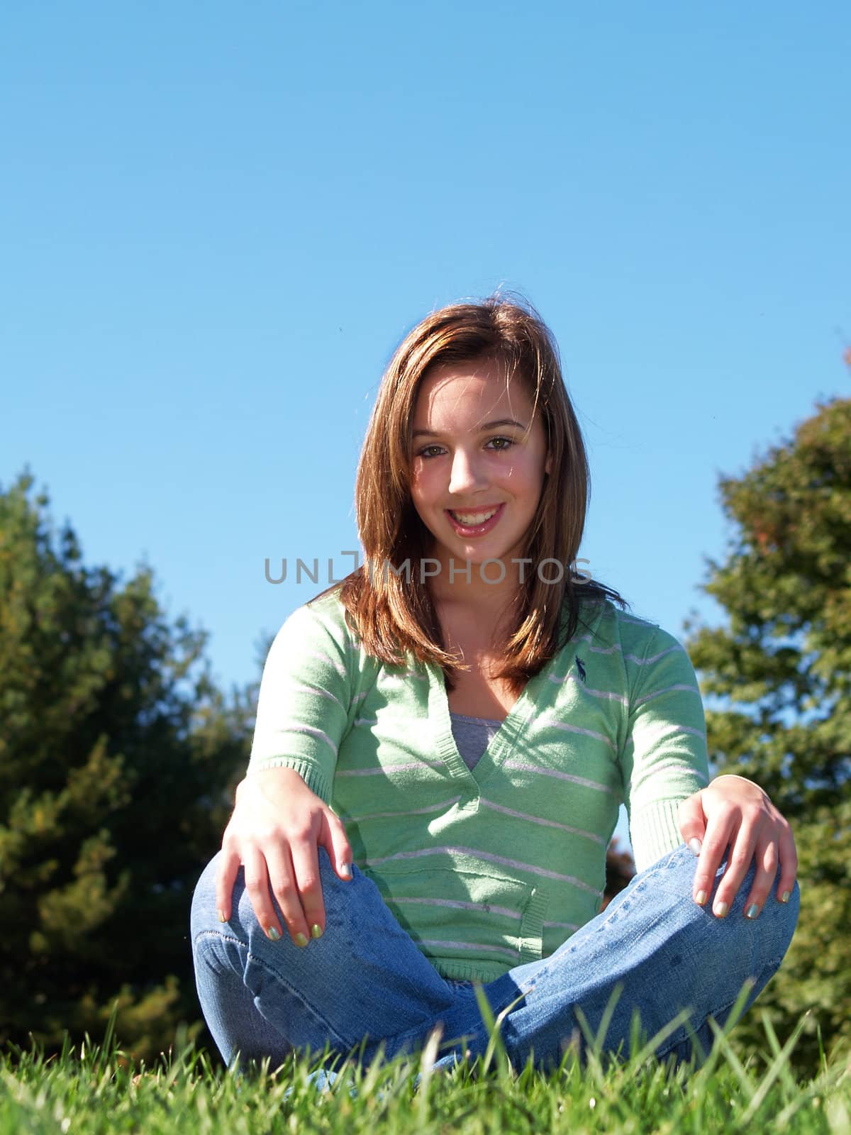 teenage girl sitting in the grass by cfarmer