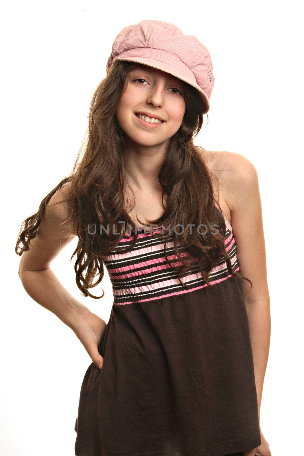 The girl in a pink cap smiles and looks in a camera