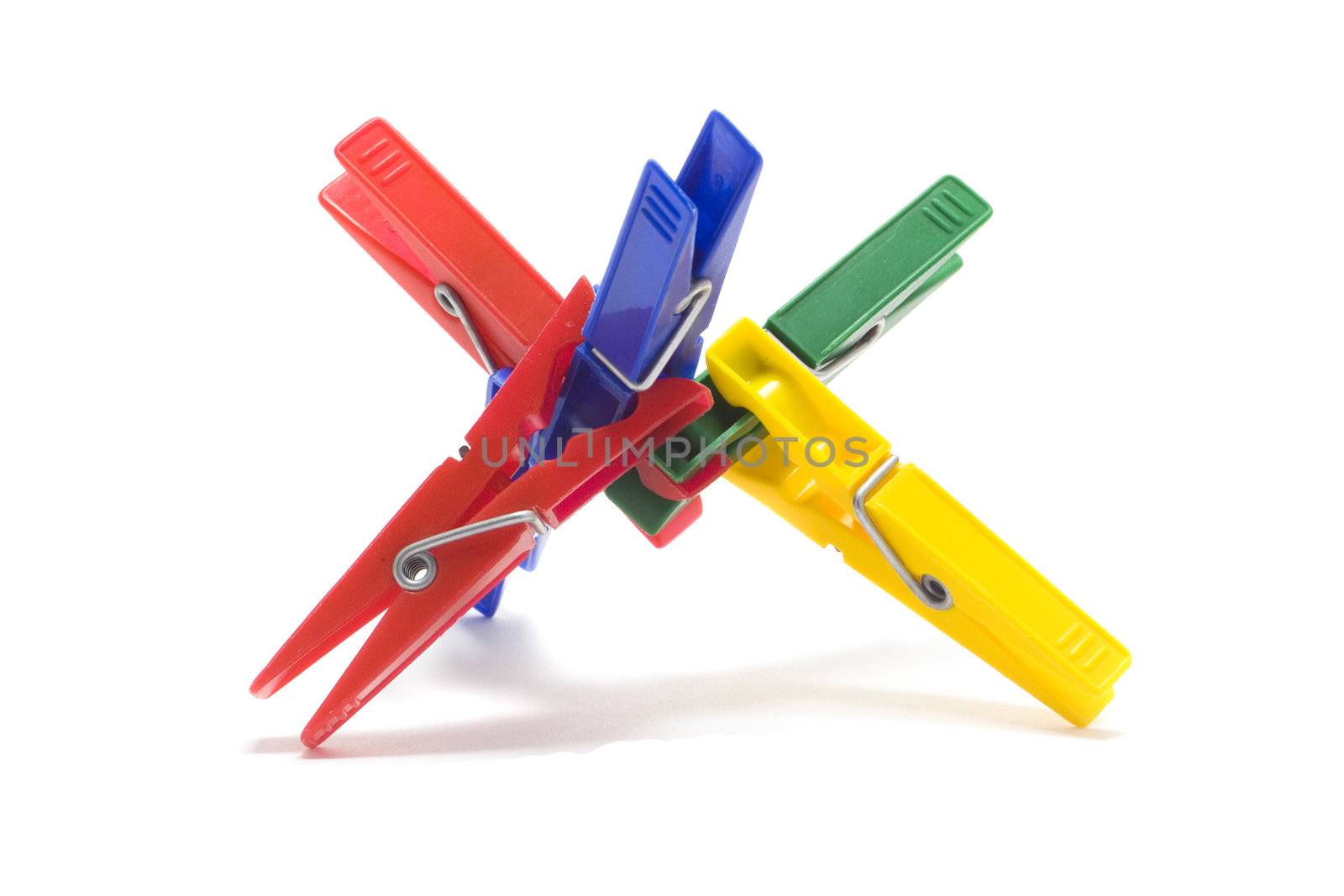 Multi coloured clothes-pegs isolated on white background