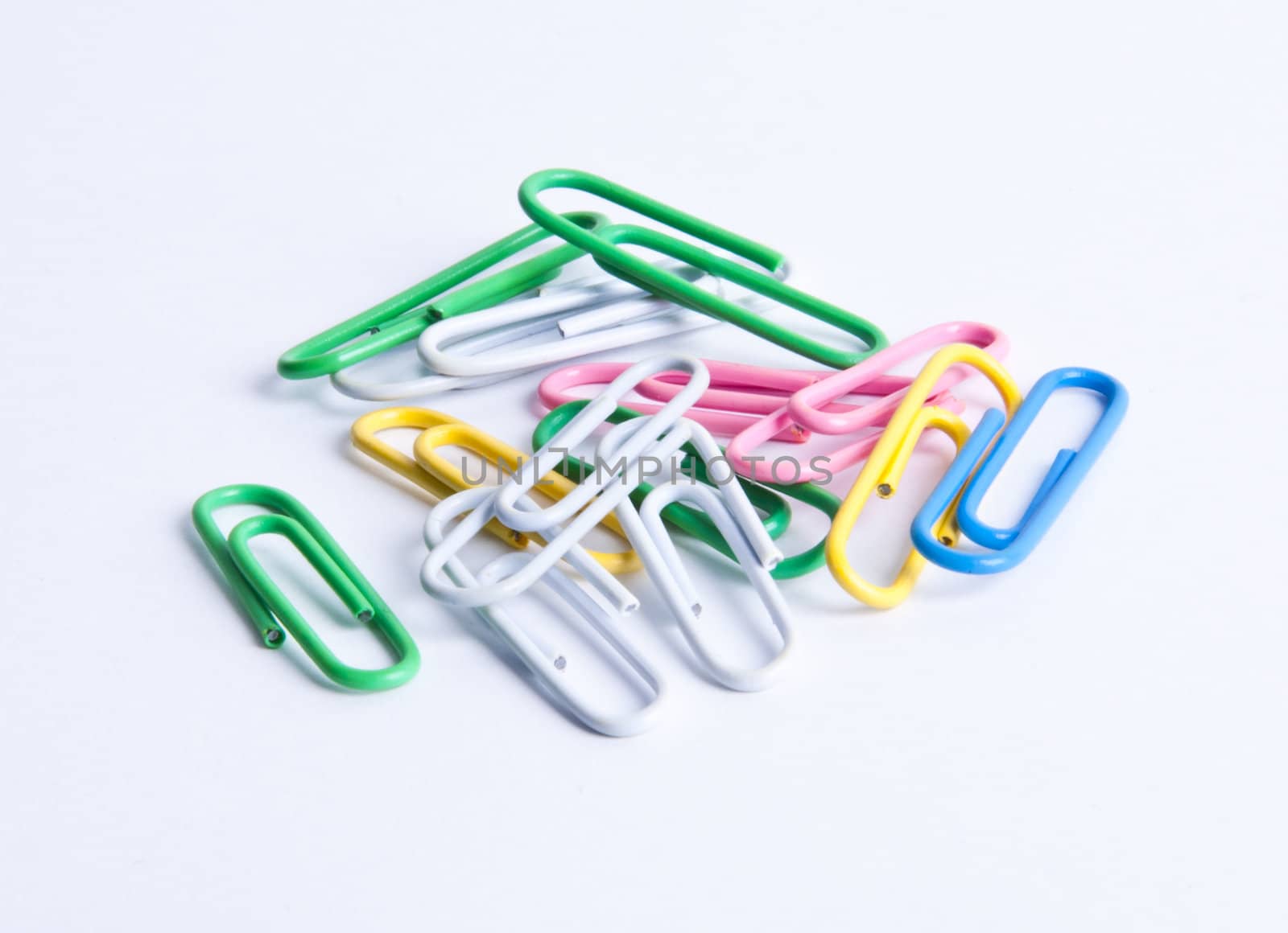 Isolated mixed colored paperclips on white background