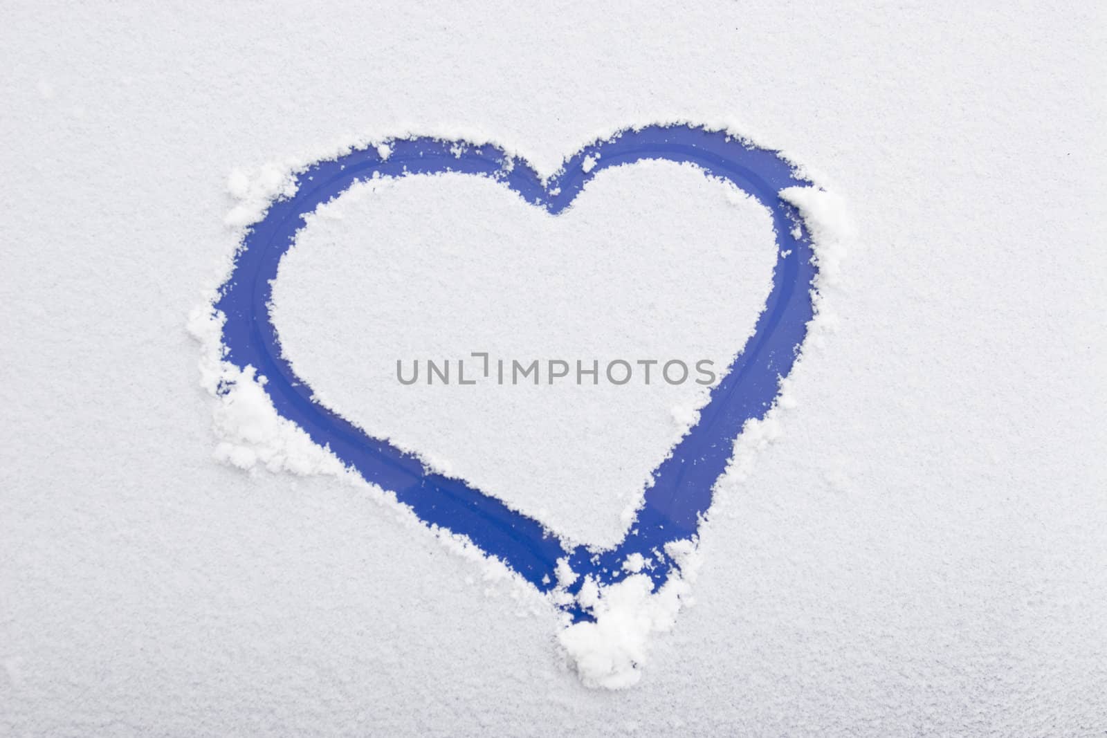 Heart shape drawn on white snow, love symbol for Valentine Day 