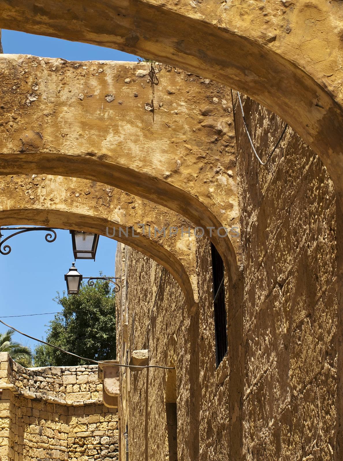 Old textured arches in one of the medieval streets in the citadel in Gozo