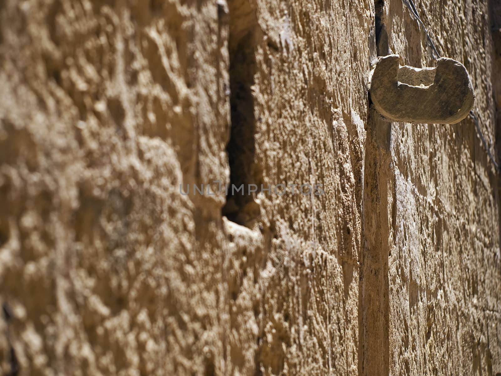 Typical texture of a Maltese limestone wall with water spout