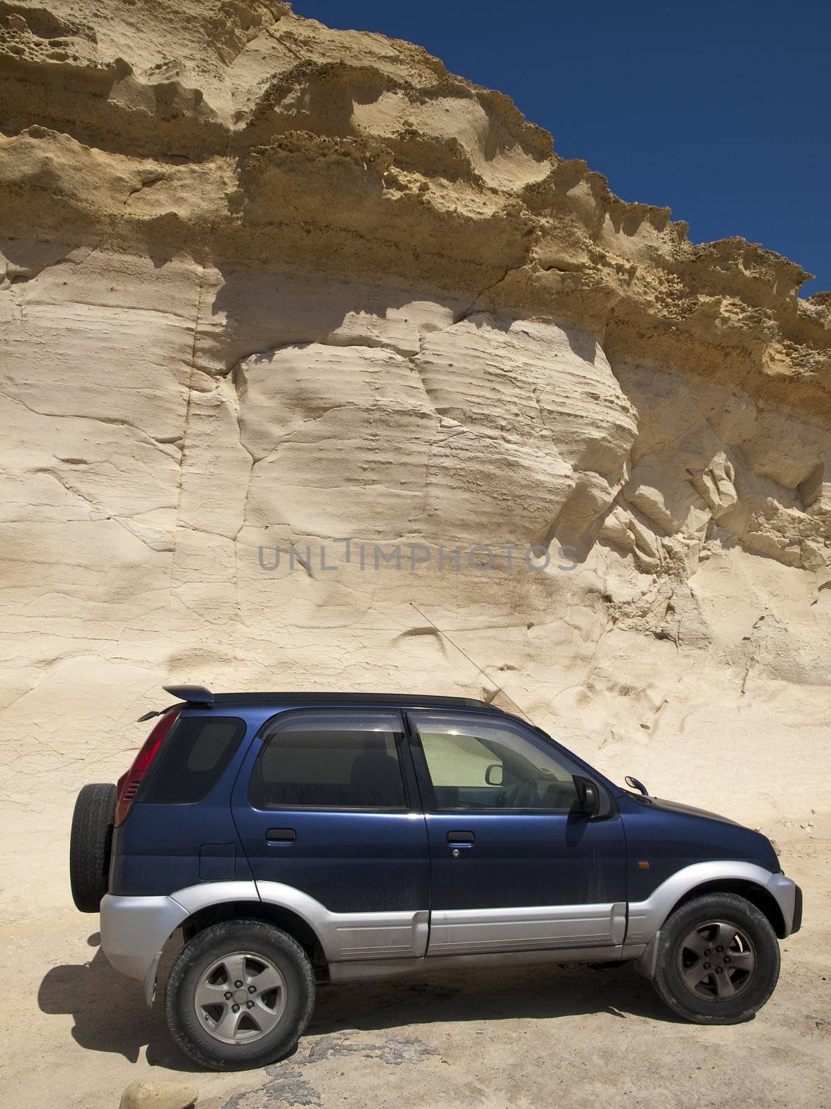 Offroad sport utility vehicle near a rocky cliffside